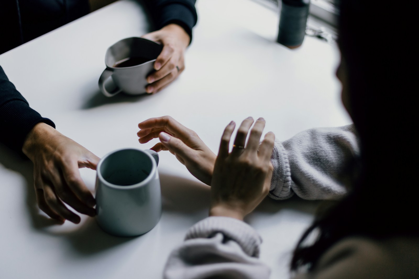 A group of people sitting and talking around a table