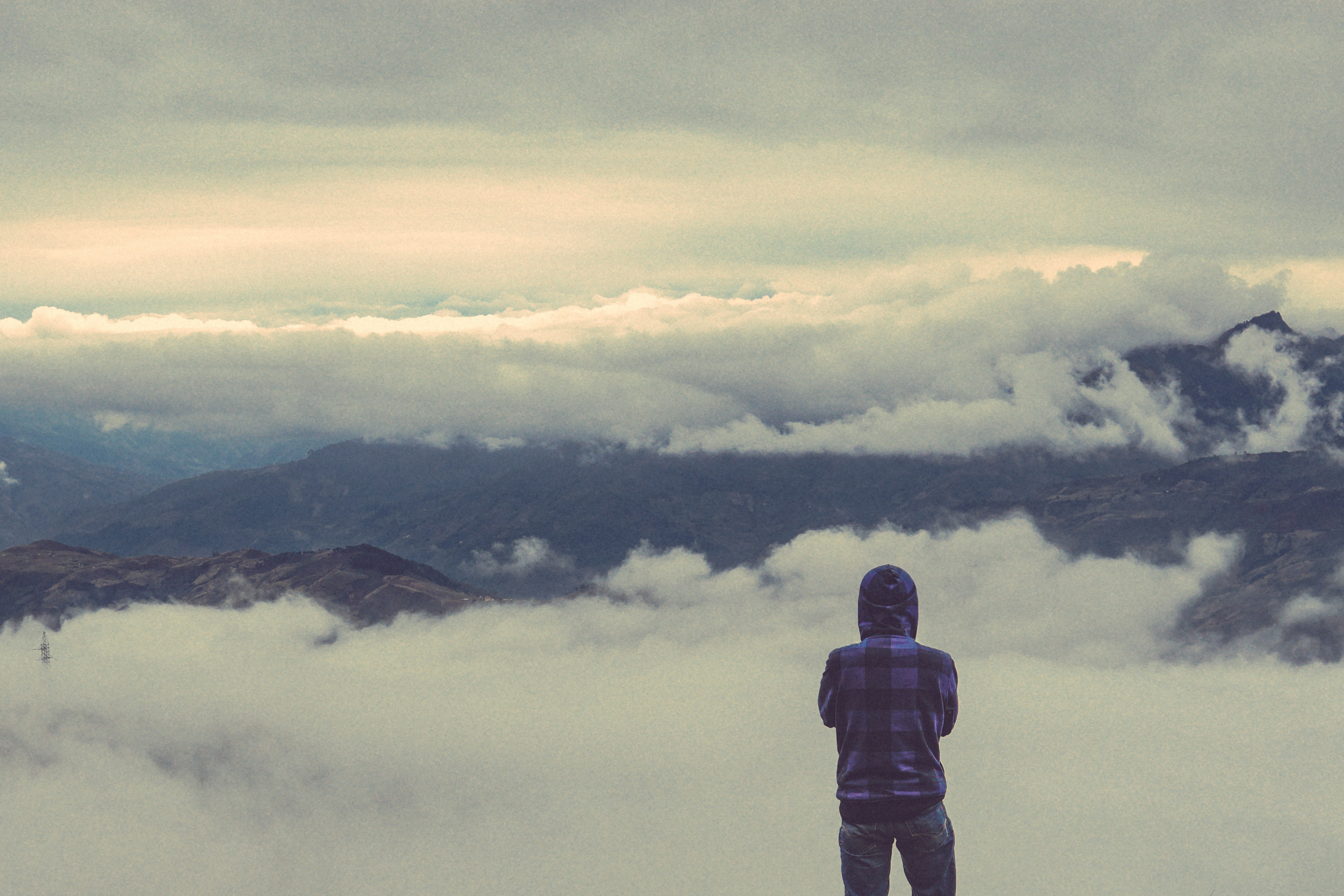 person looking at sea of clouds during daytime