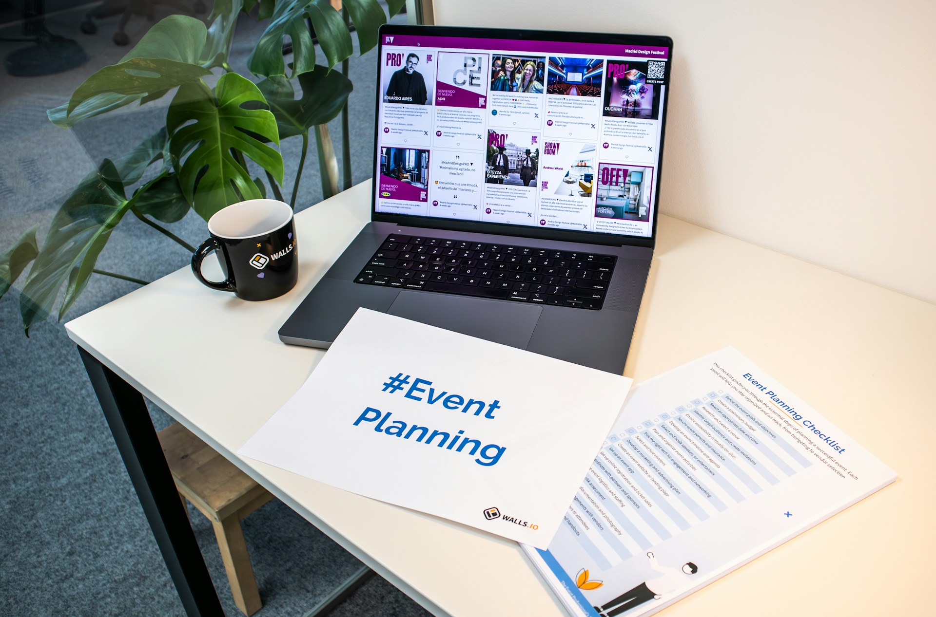 Event planning checklist and notes beside a laptop on a desk