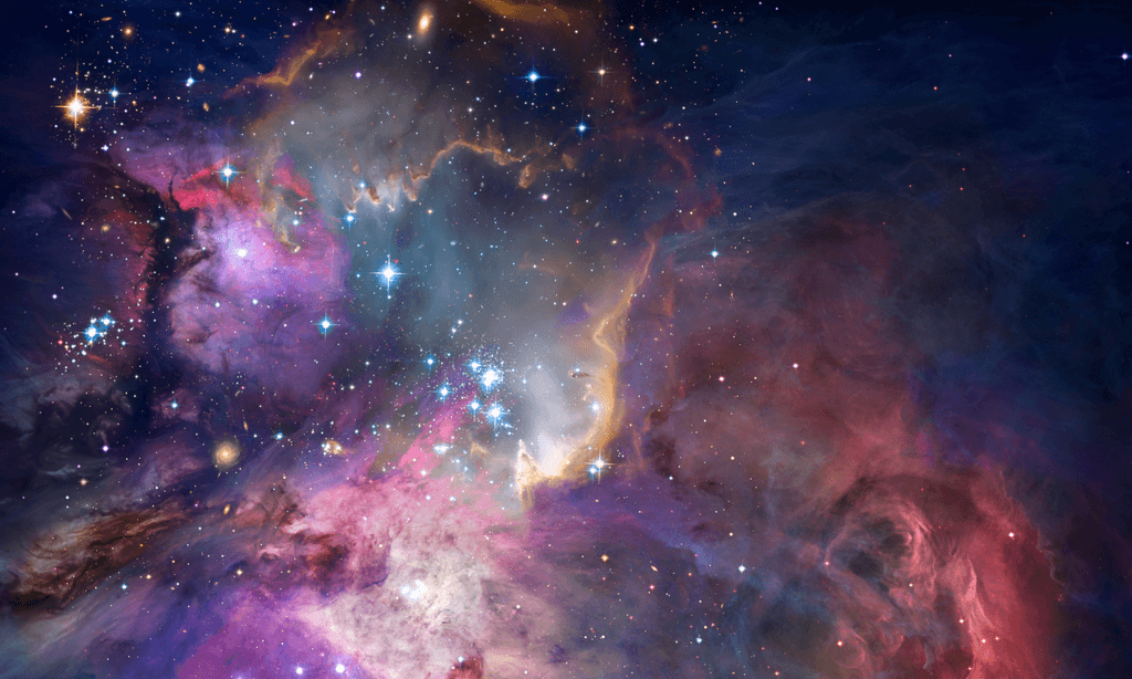 A speaker on stage, illuminated against a dark background, gestures while addressing an audience.