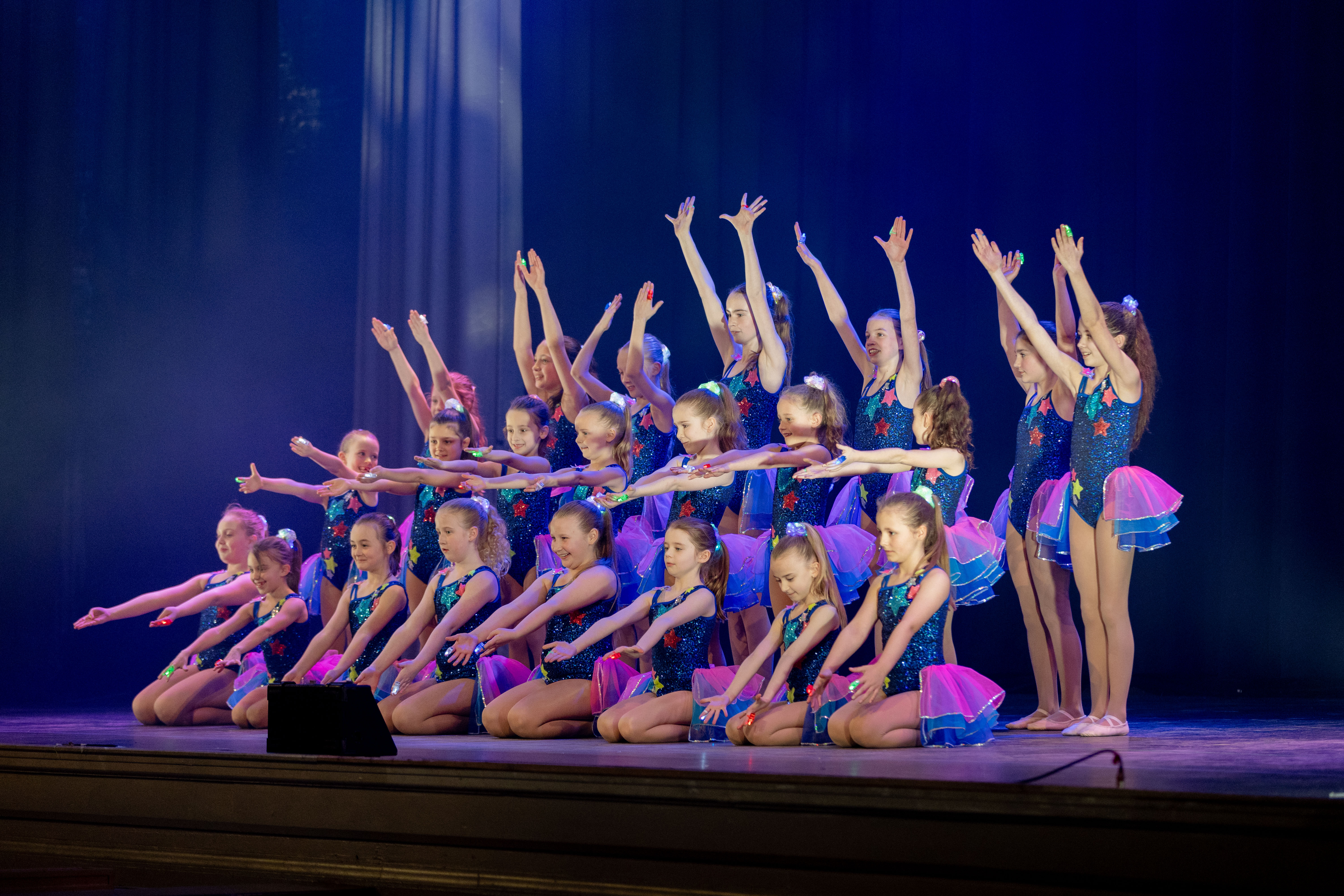 Ballerinas rehearsing on a warmly lit stage