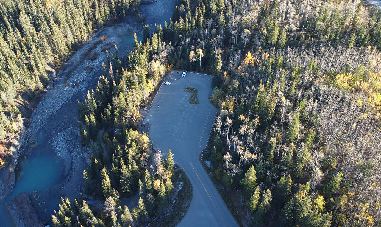 Aerial perspective of Widowmaker parking facility and river access trail surrounded by forest