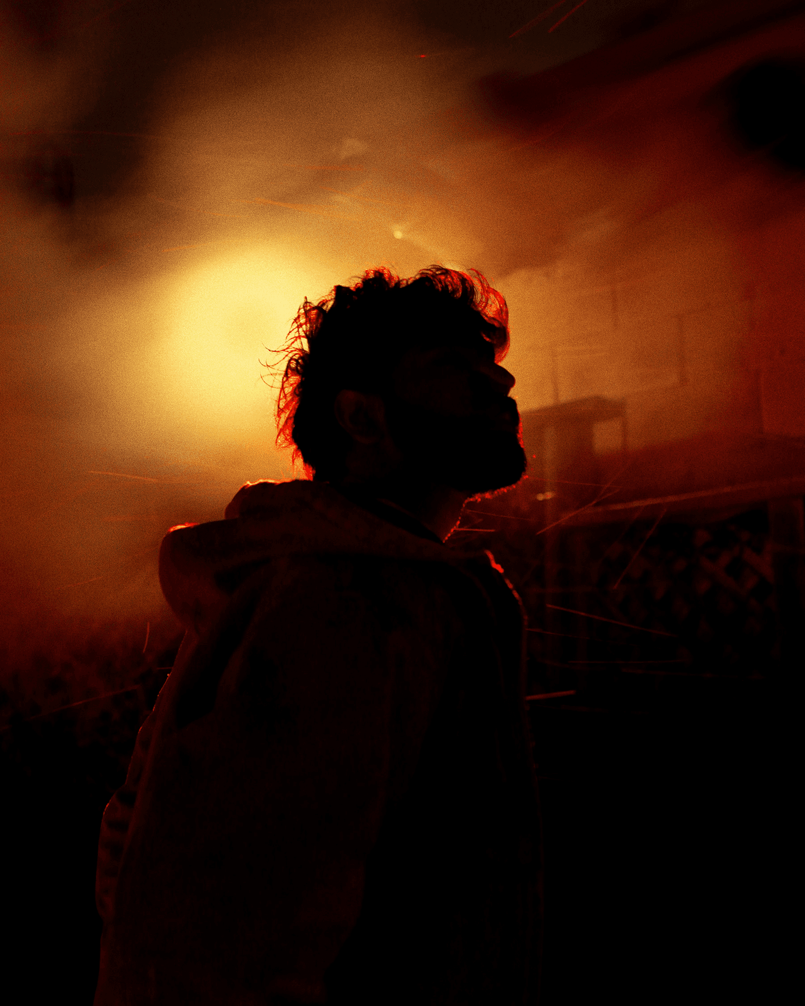 Silhouette of person in misty orange light.