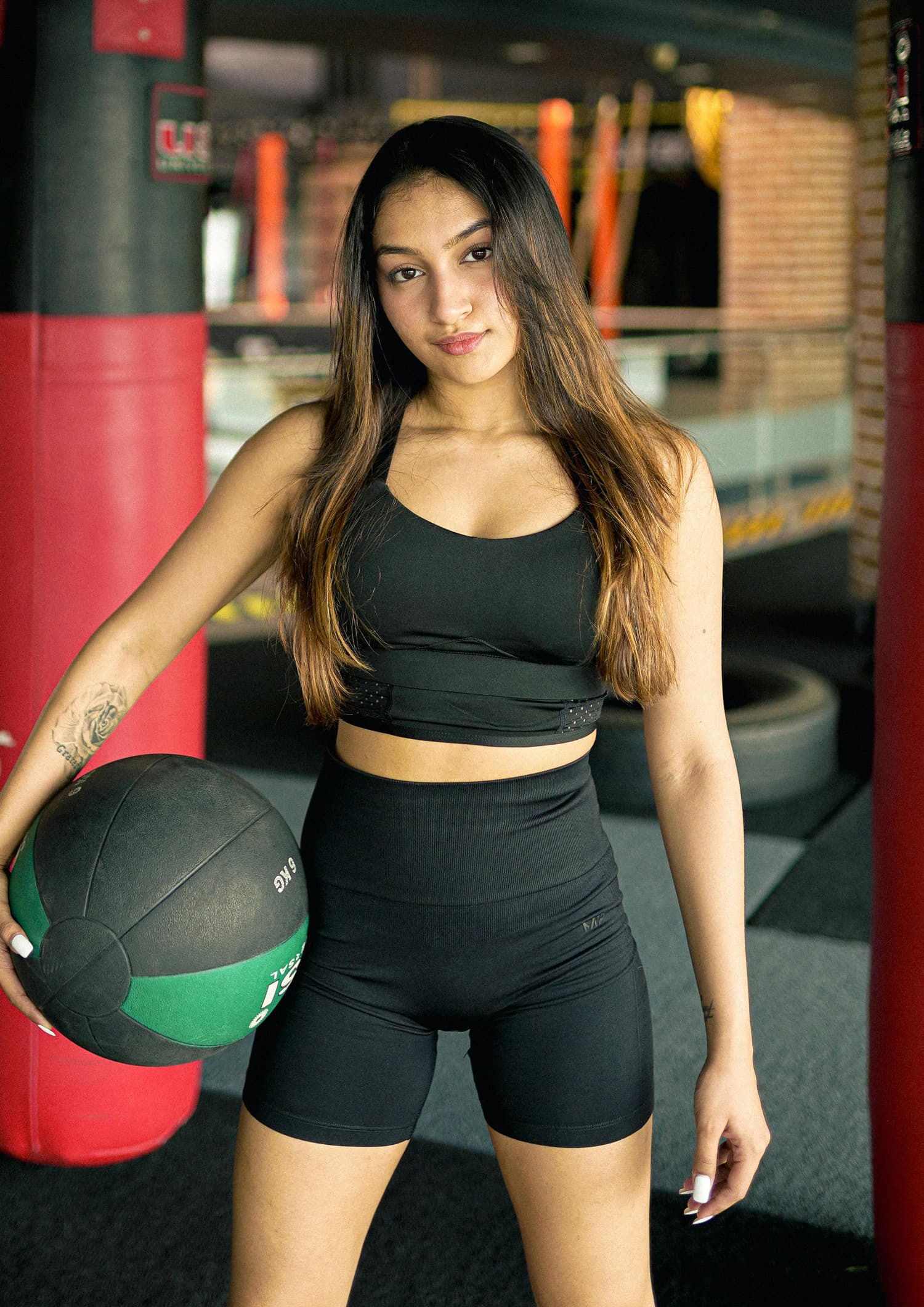a woman with her arms crossed posing for a picture