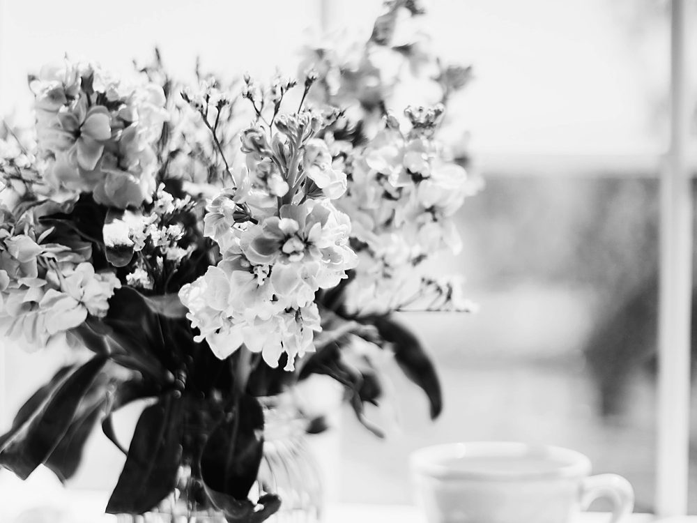 Flowers, notebook and teacup