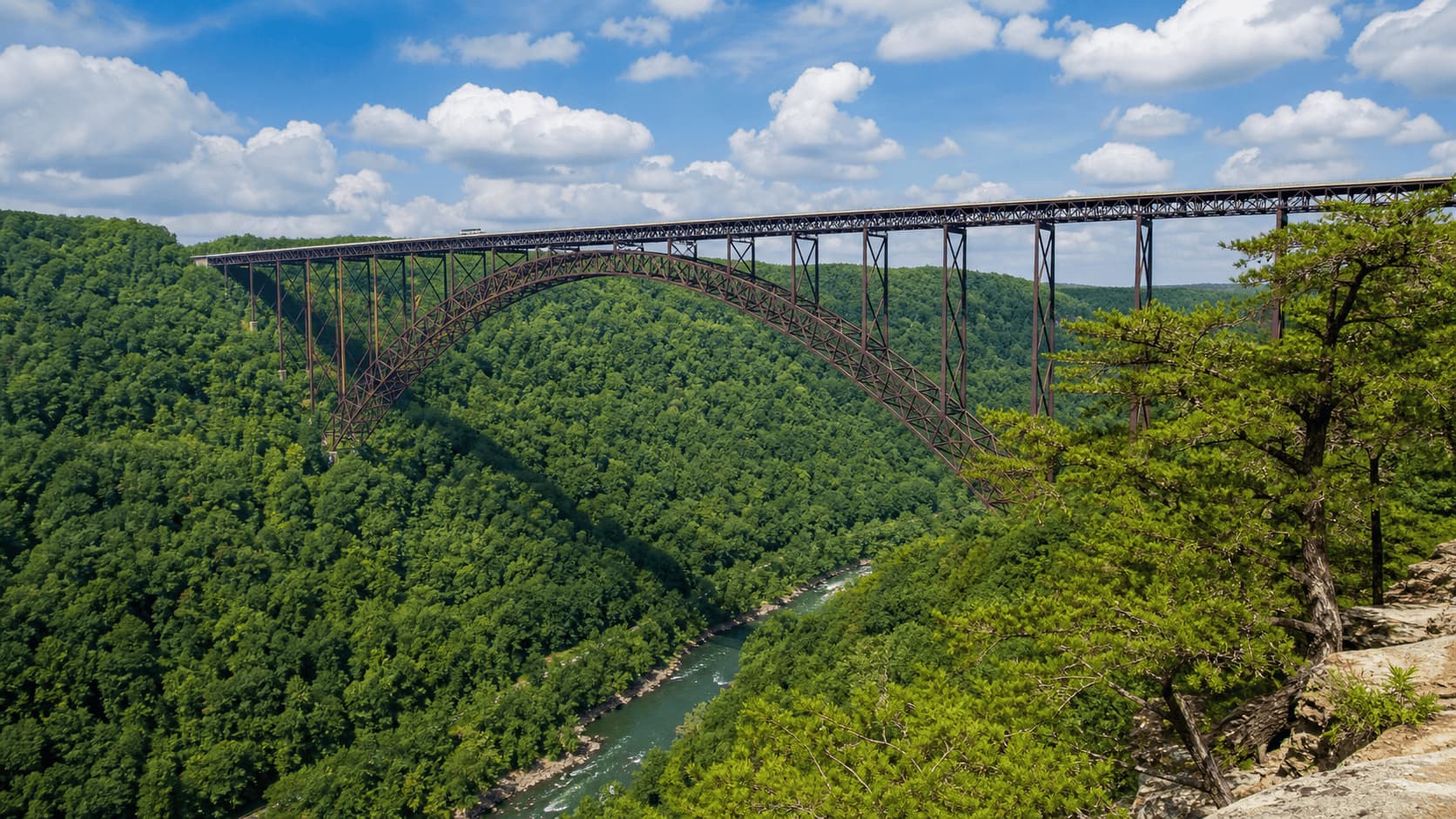 New River Gorge Bridge surrounded by forest landscape in West Virginia