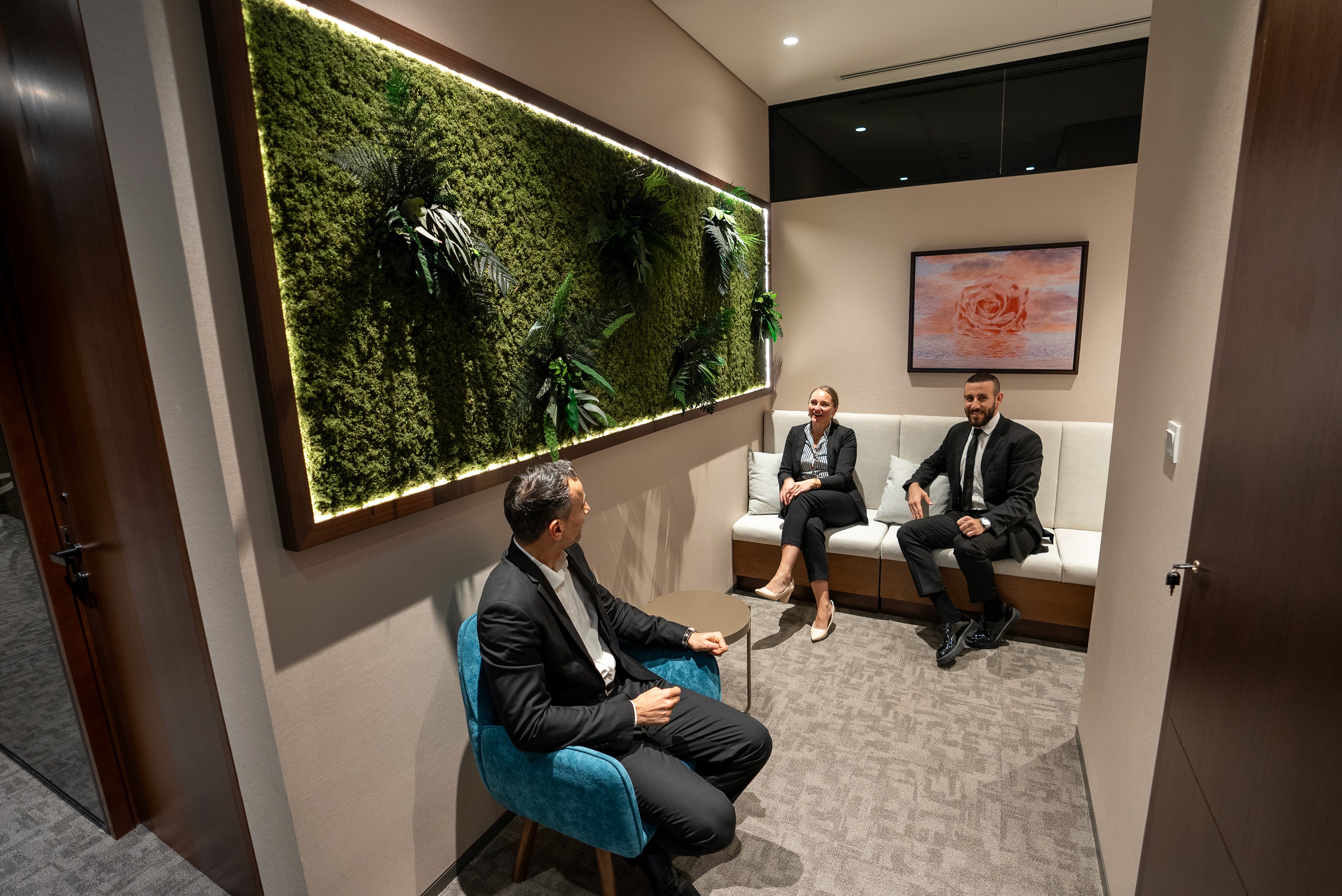 Small private meeting lounge with built-in greenery in a coworking space in Abu Dhabi.