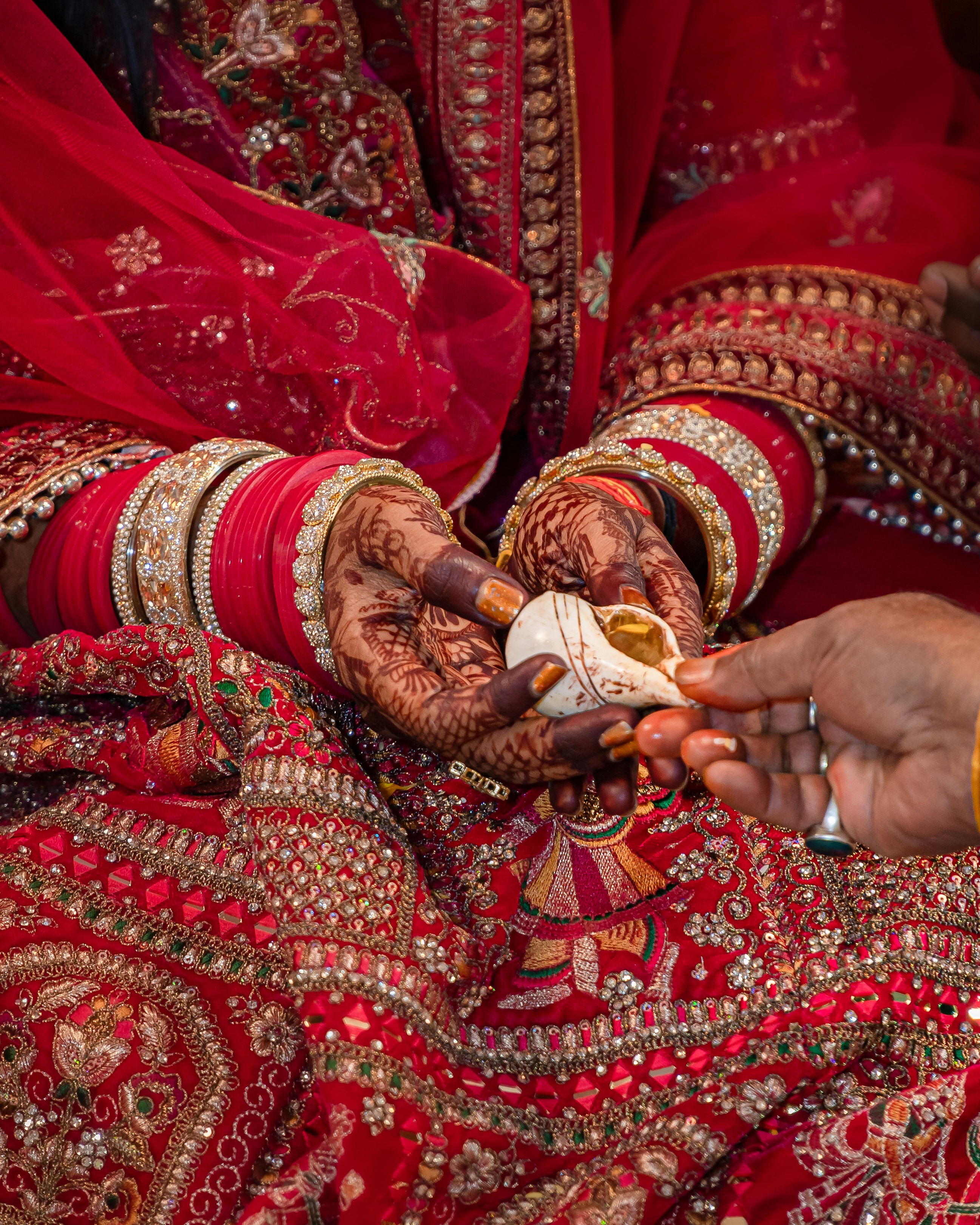 Bride holding a conch shell during a wedding ceremony.
