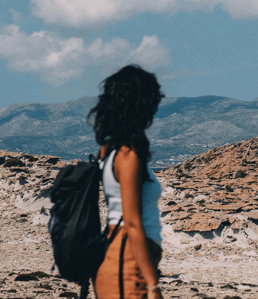 woman standing on brown sand under blue sky during daytime