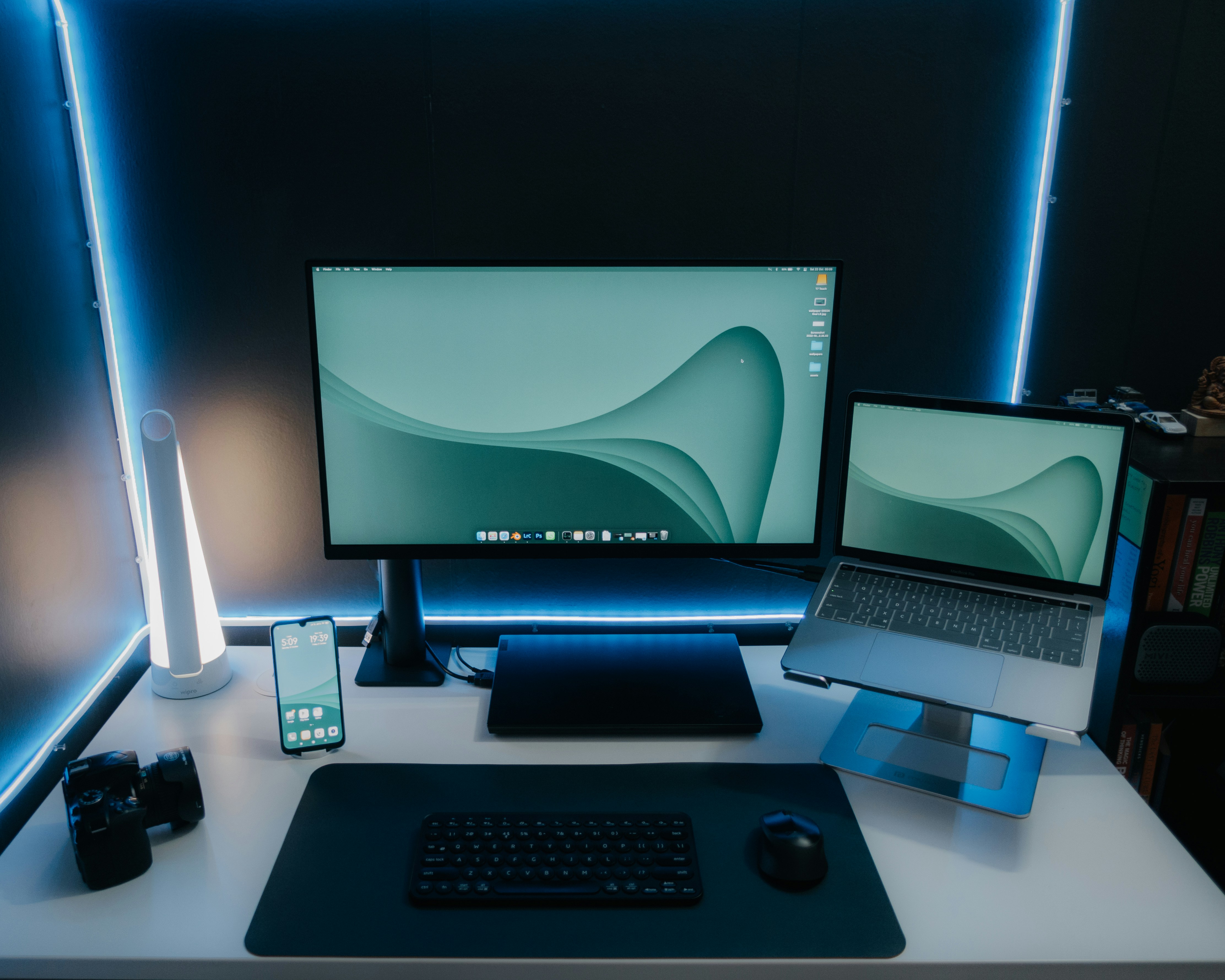 a desk with a laptop and a monitor