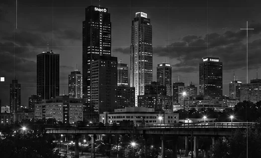 Grayscale illustration of a city skyline at night