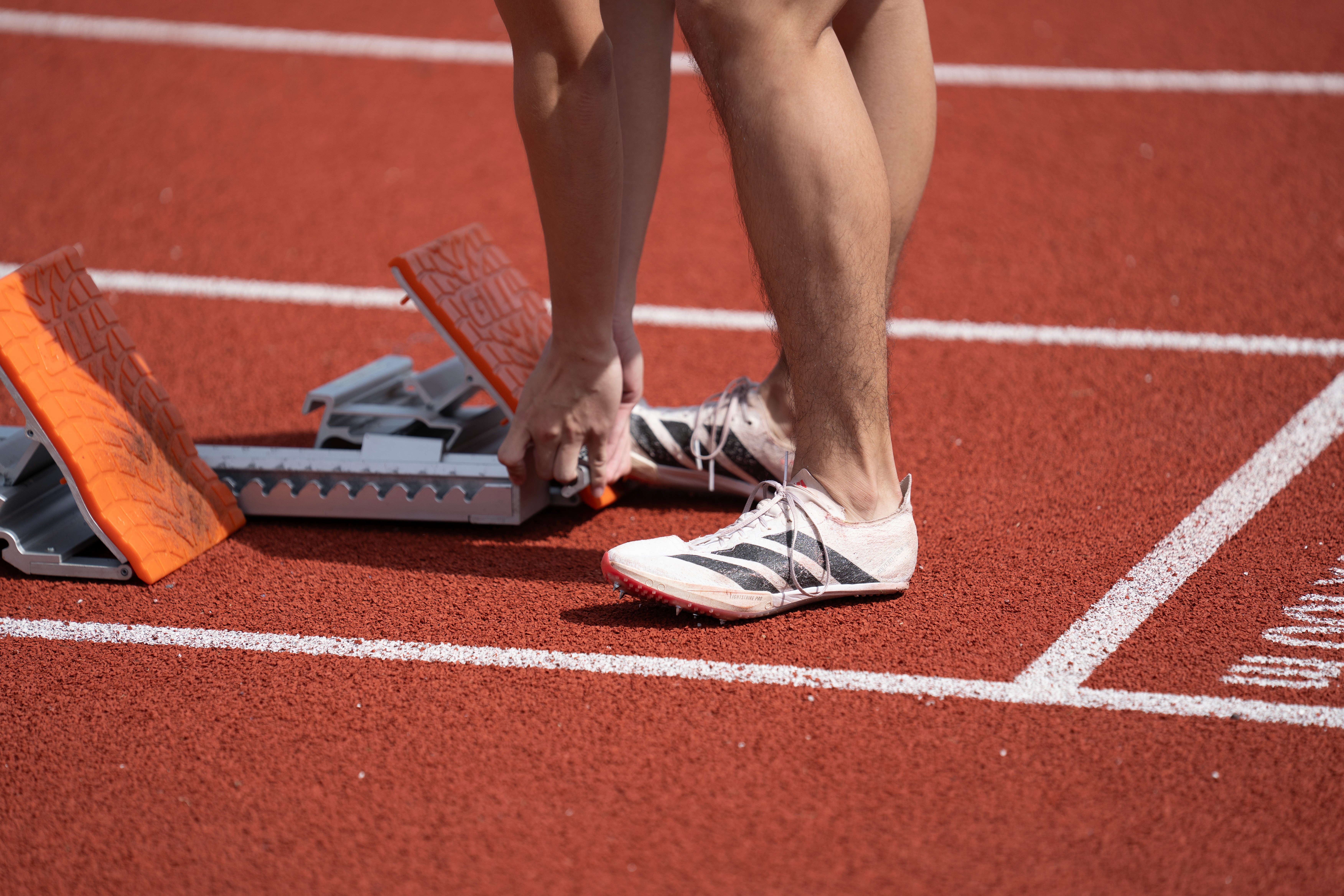 Close-up of runner's spikes on track at inter-polytechnic championships 2026
