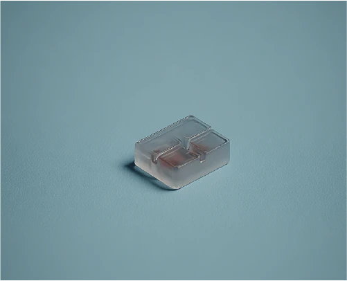 Small white cube of testing polymer on a simple, contrasting background.