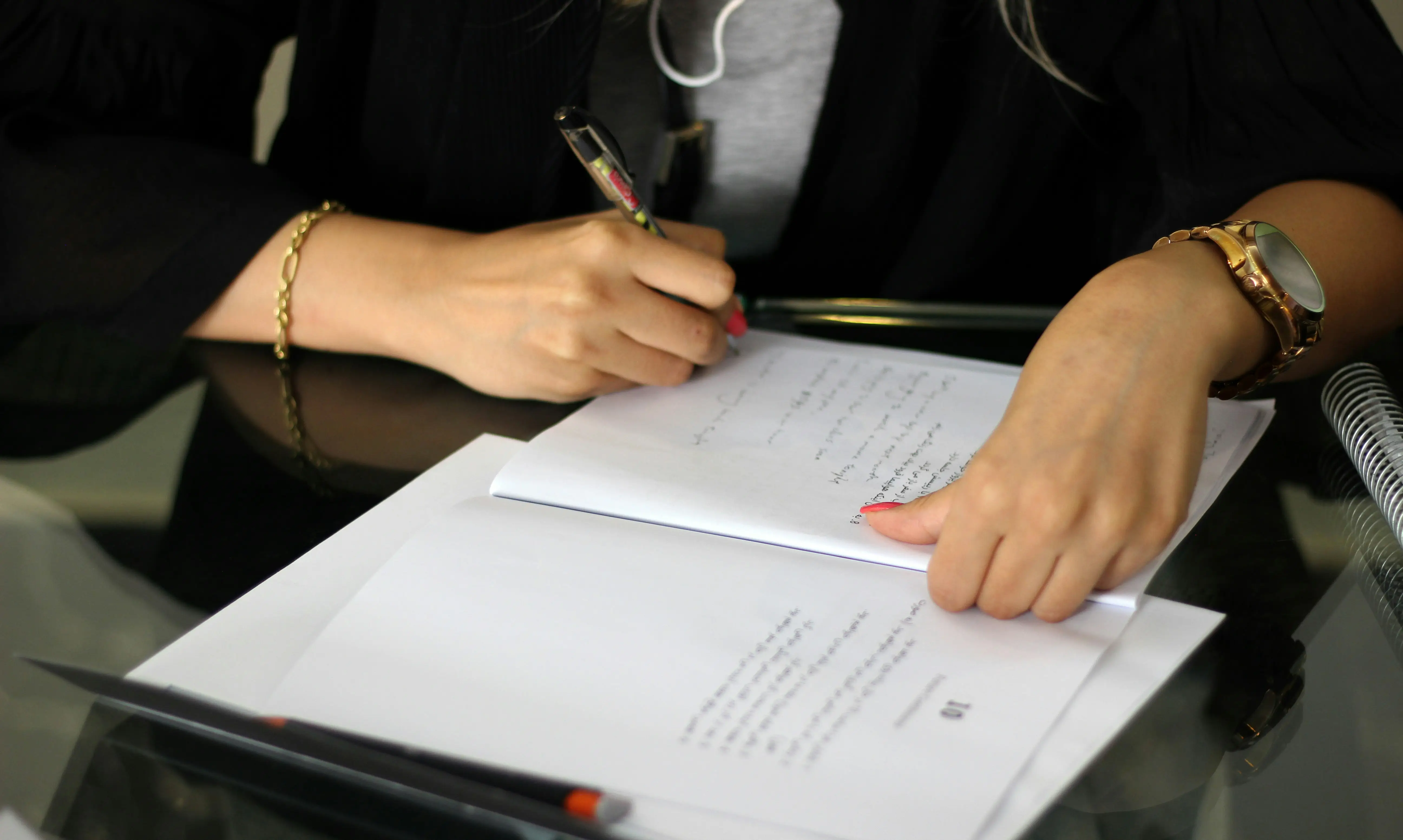 man writing on paper