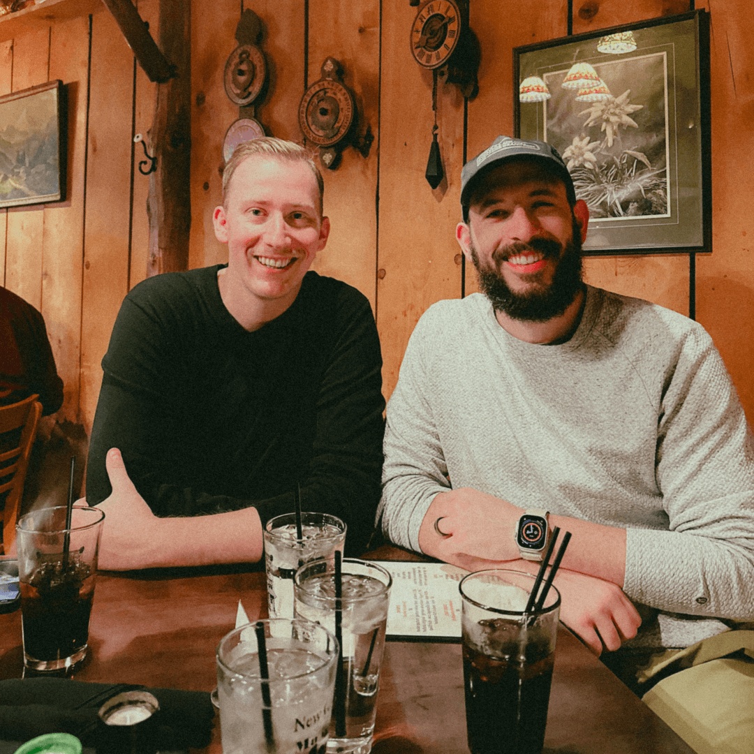 People playing soccer on a rooftop court surrounded by city buildings