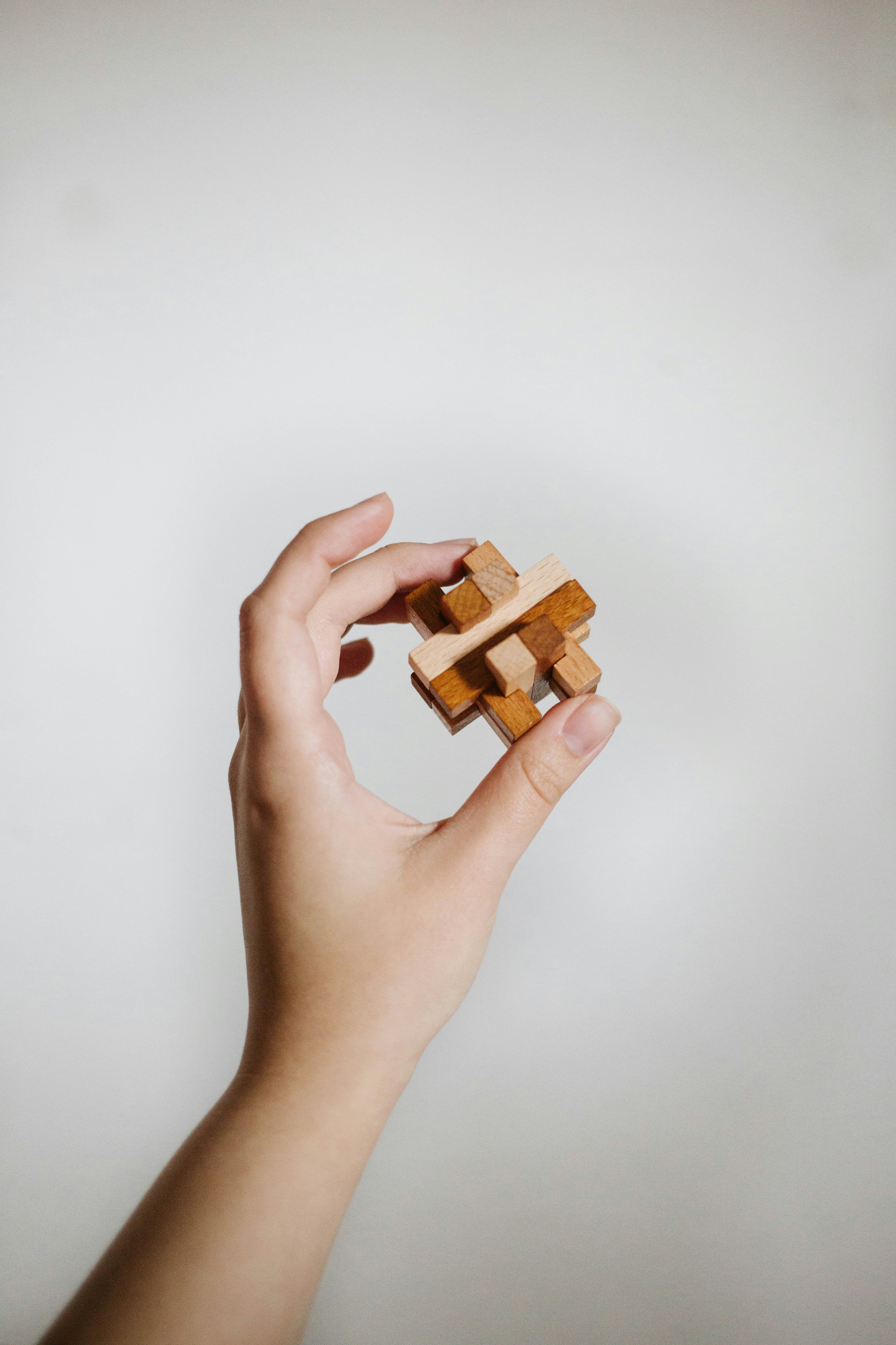 a person holding a wooden block in their hand
