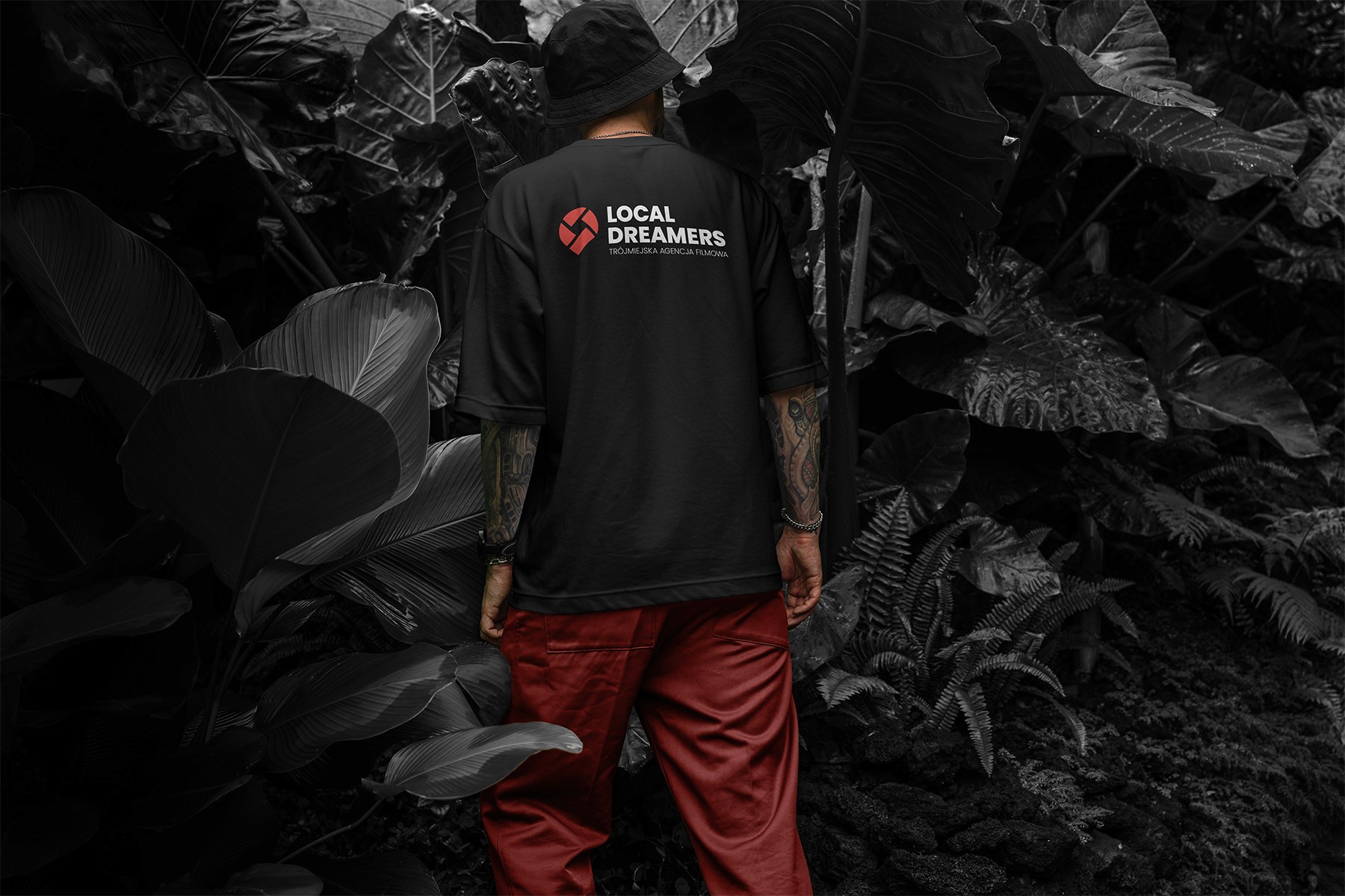 Zdjęcie człowieka w koszulce z nadrukowanym logo Local Dreamers na plecach