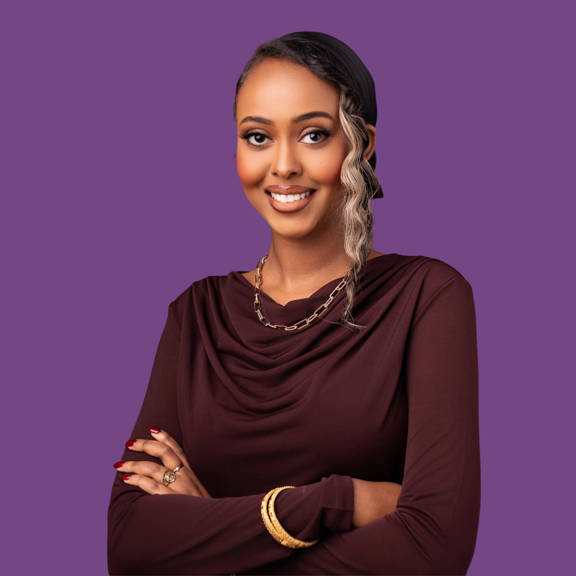 woman in black blazer covering her face with her hand