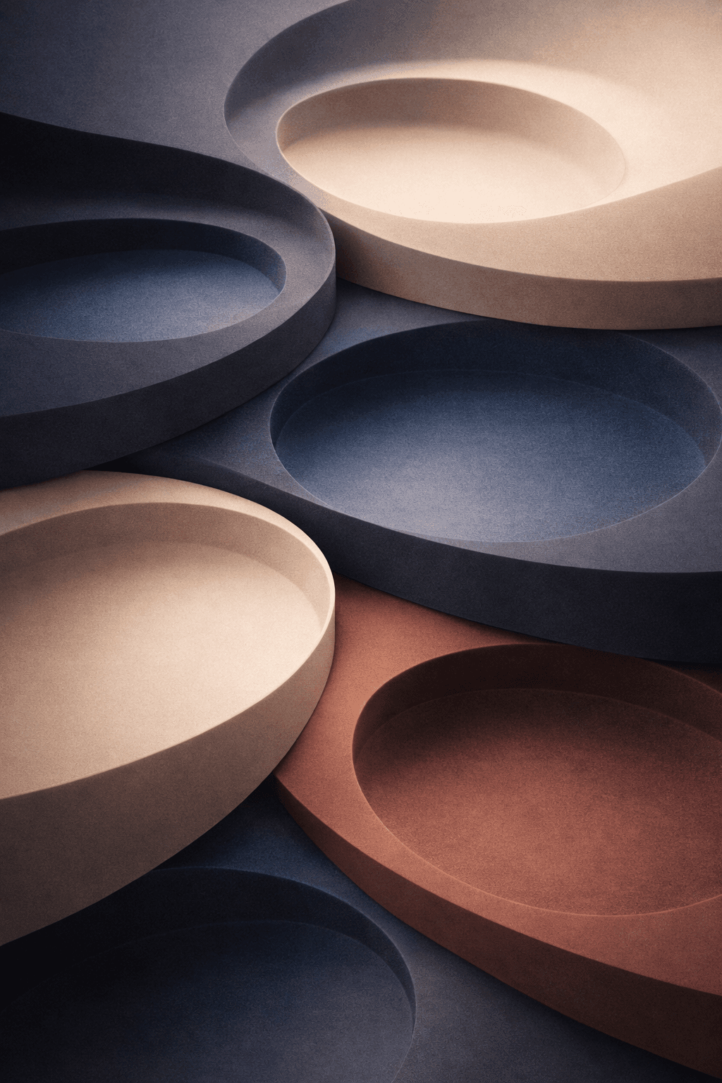 A smiling young man with crossed arms, wearing a plaid shirt and white t-shirt, poses against a dark background.