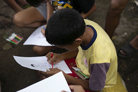 kids drawing their future self in a paper