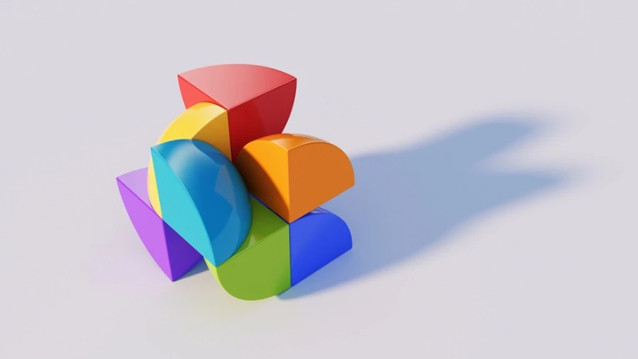 3D abstract composition of colorful geometric shapes—red, orange, yellow, green, blue, and purple—arranged in a stacked structure casting a soft shadow on a light background.