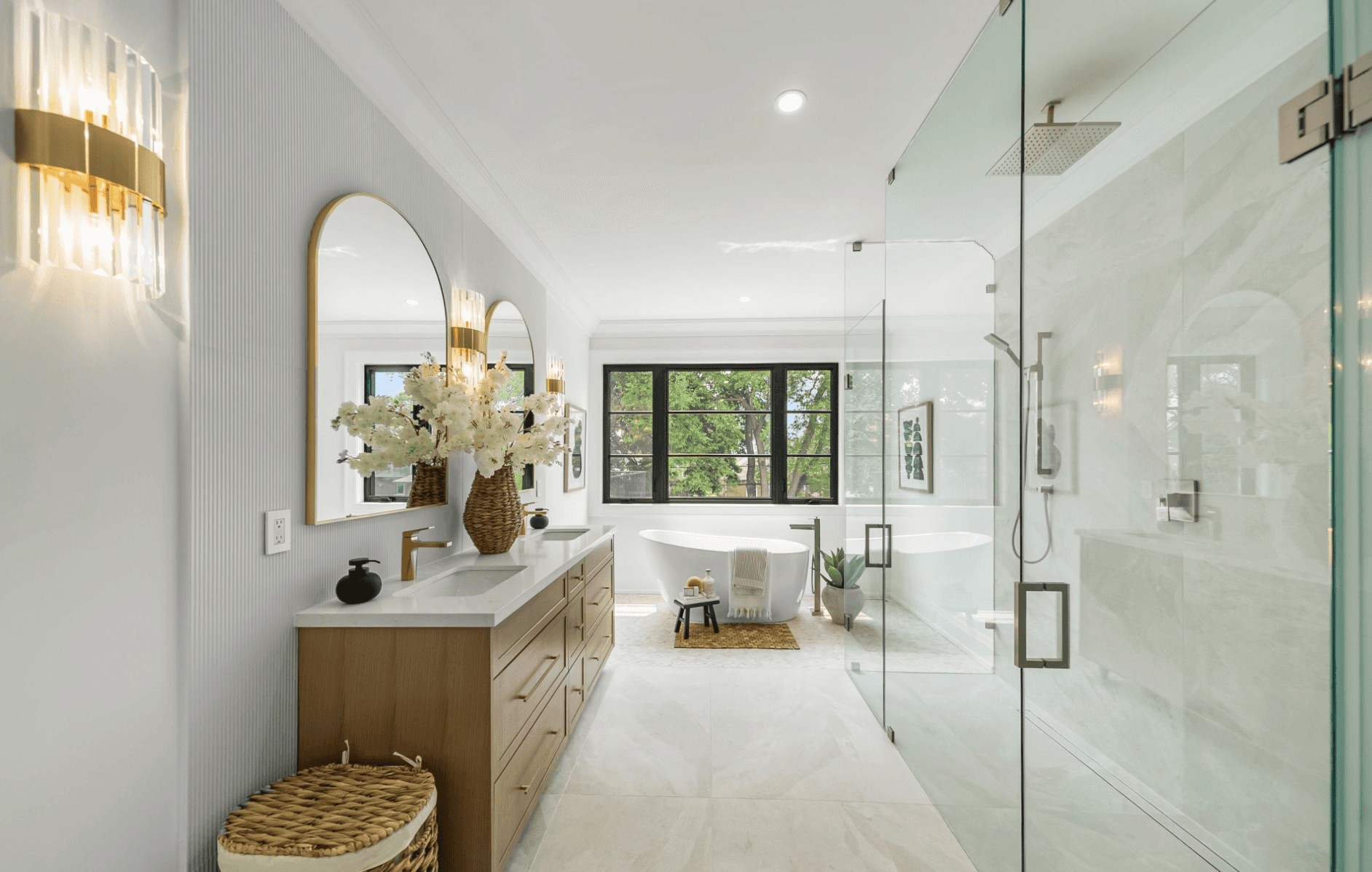 Modern bathroom featuring wooden cabinetry, a bathtub, a sleek sink, and natural light from a window.