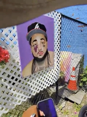 Portrait artwork mounted on white lattice beside an outdoor walkway