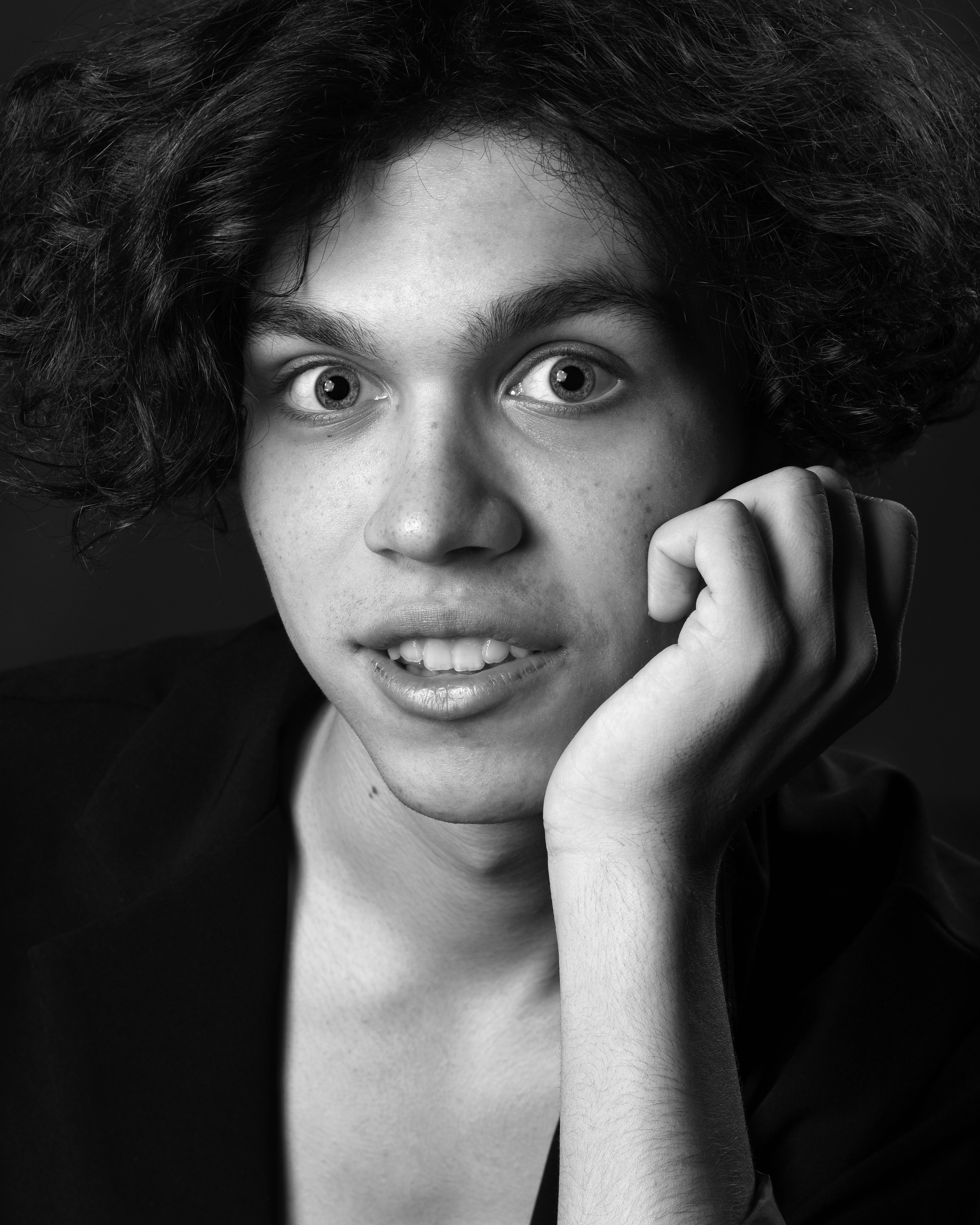 a black and white photo of a person with curly hair
