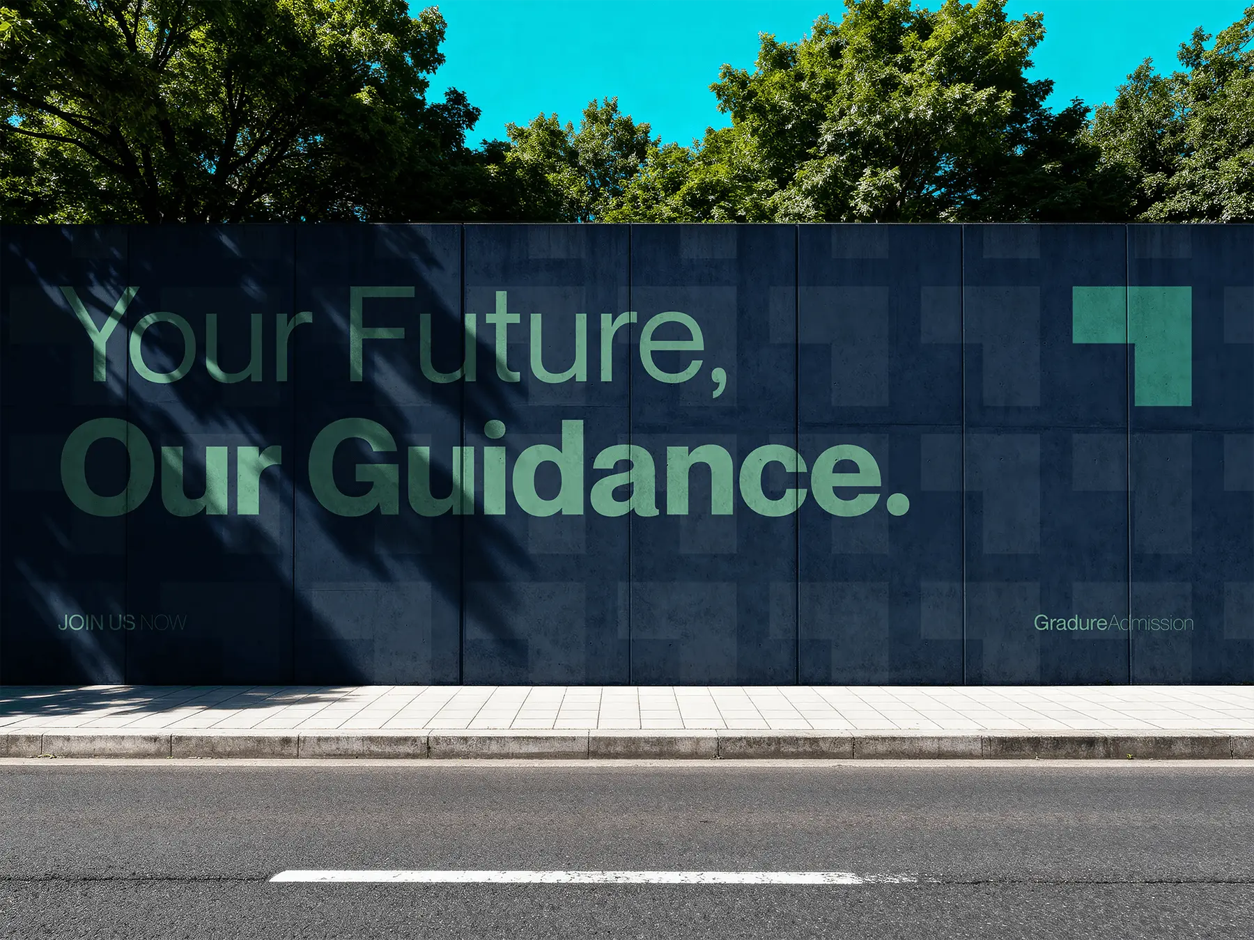 Large outdoor wall display featuring the Gradure Admission brand message ‘Your Future, Our Guidance.’ in mint green typography over a dark blue patterned backdrop with the signature block icon.