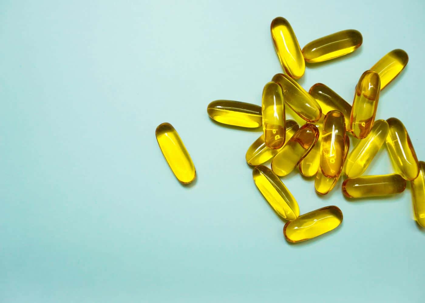 Yellow supplements on a teal flat surface