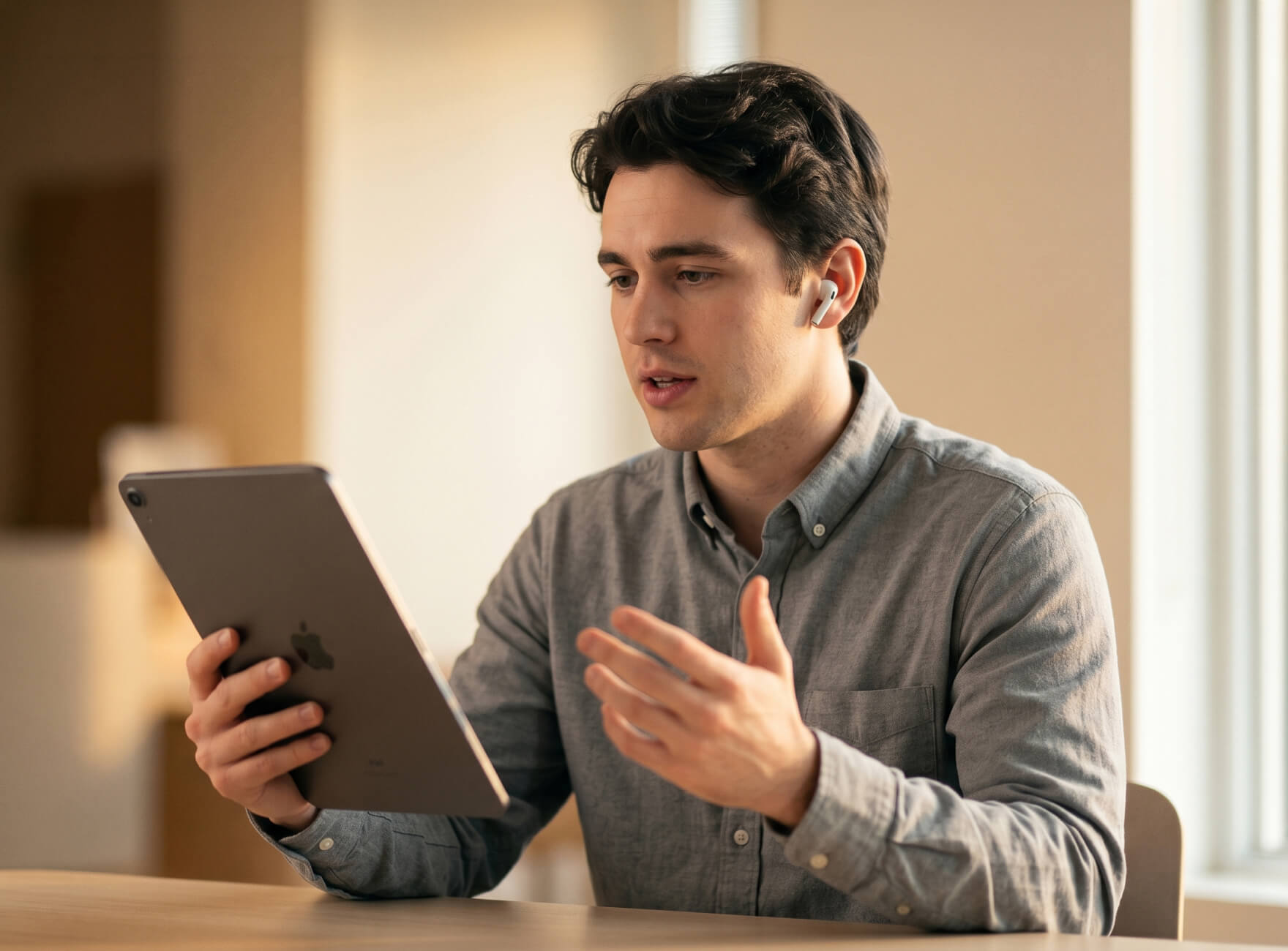 A desk with a laptop and an employee badge laying on top of it.