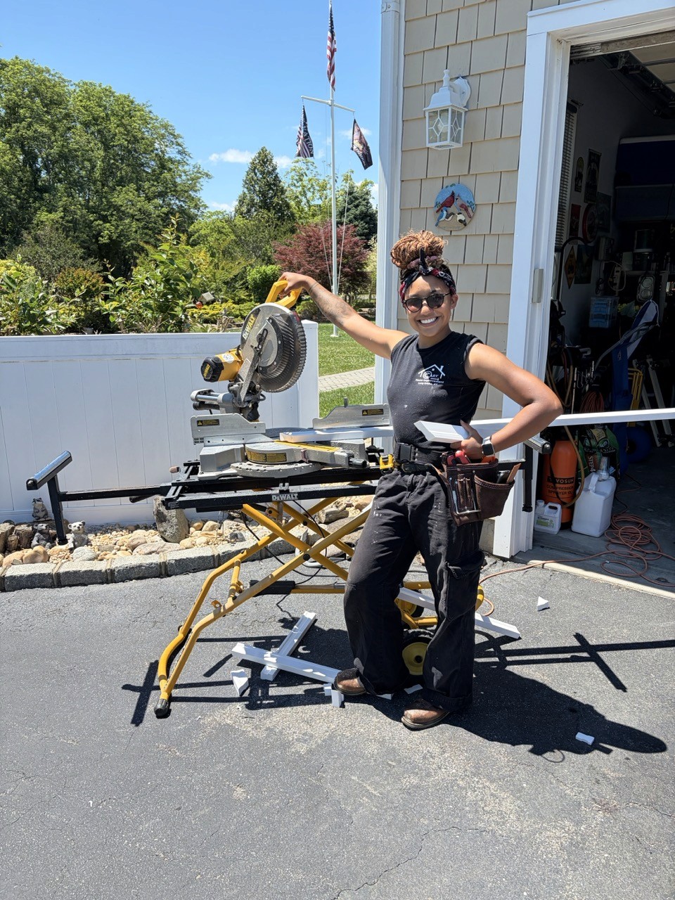 Cary Home Improvement crew member powerwashing a home exterior from a ladder