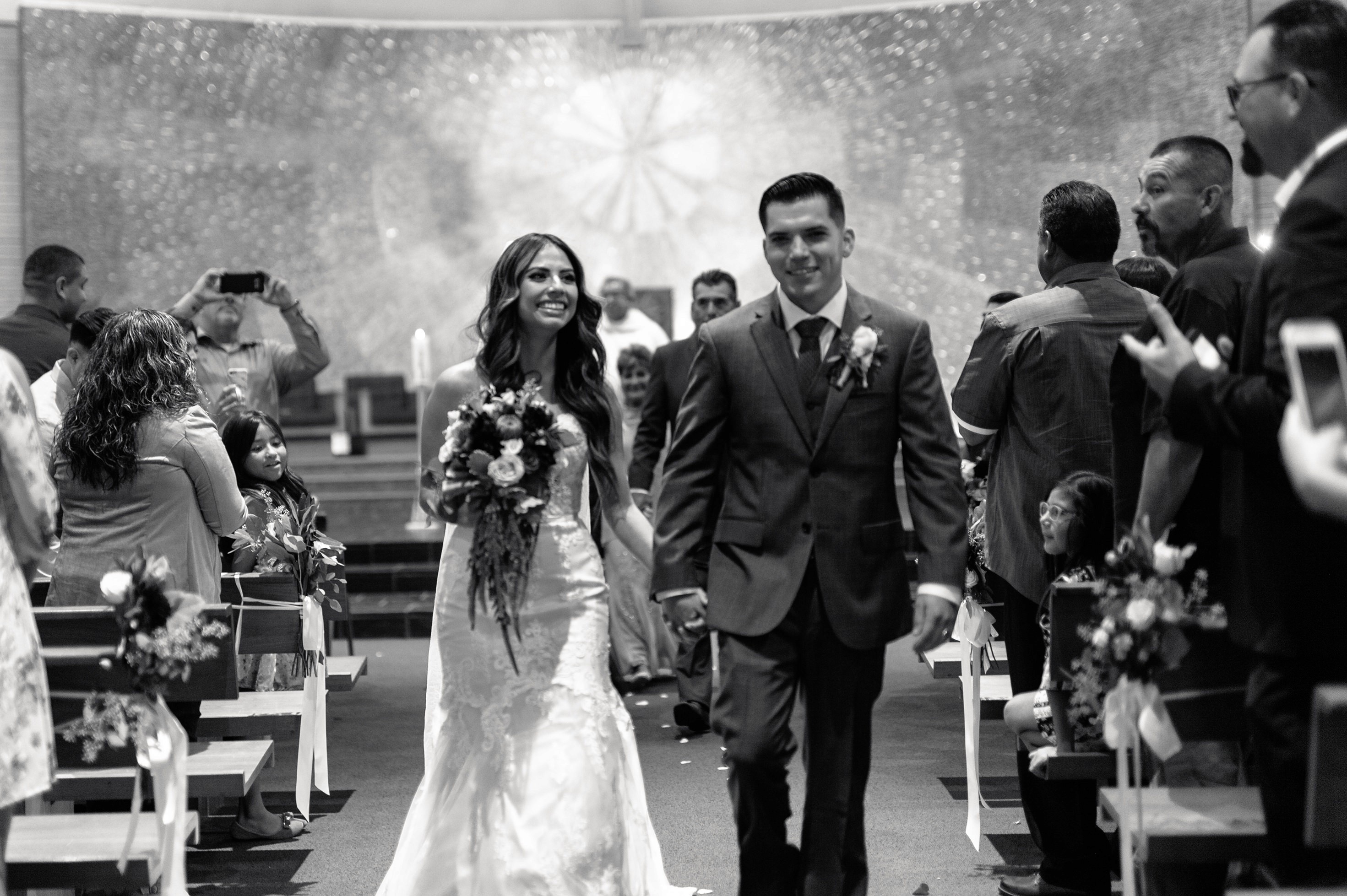 Bride and groom walking down the aisle after the ceremony