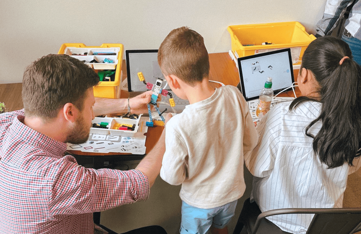 People looking at photos on a computer screen.