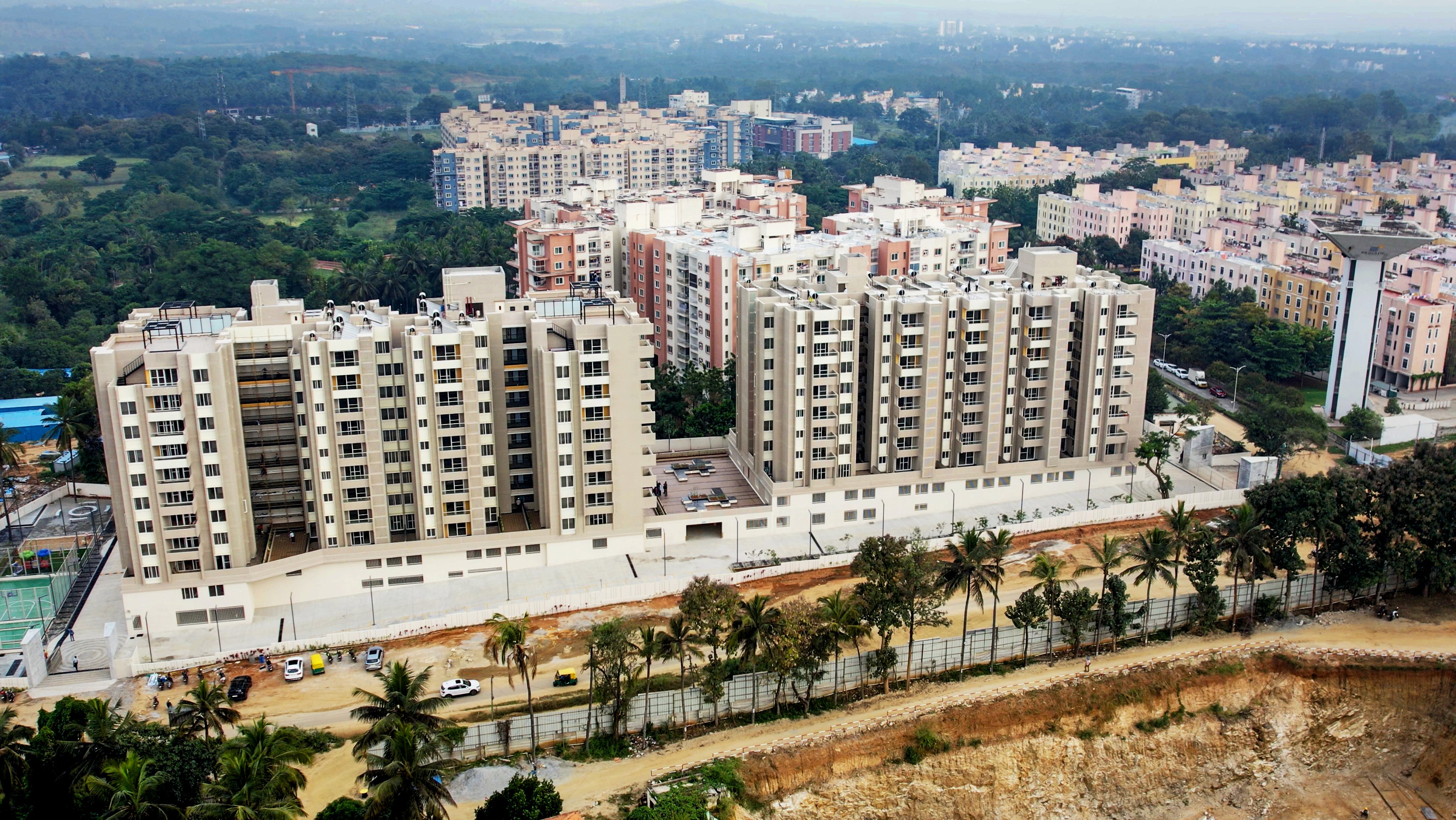 Aerial view of a winding road cutting through rocky terrain with patches of grass.