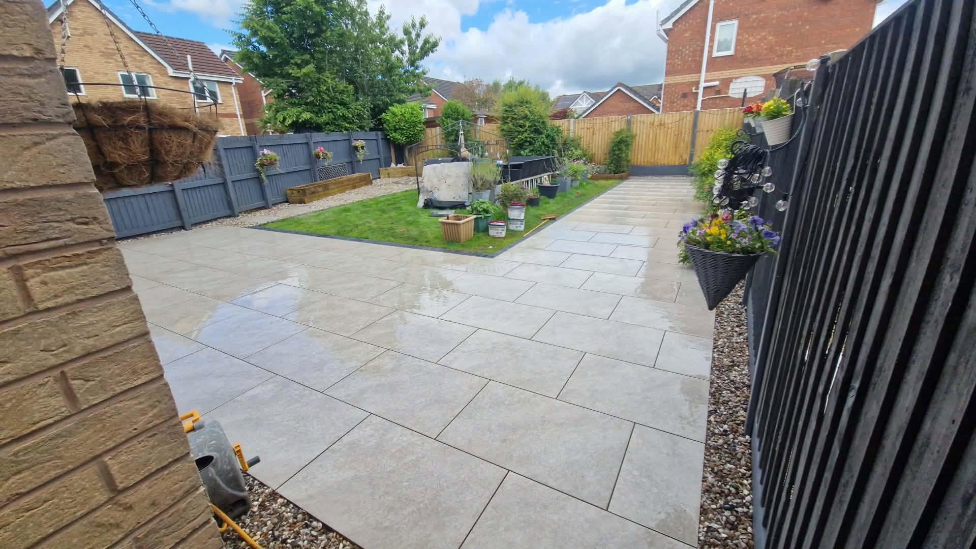 Completed garden transformation with porcelain paving, fencing and landscaped borders in Manchester