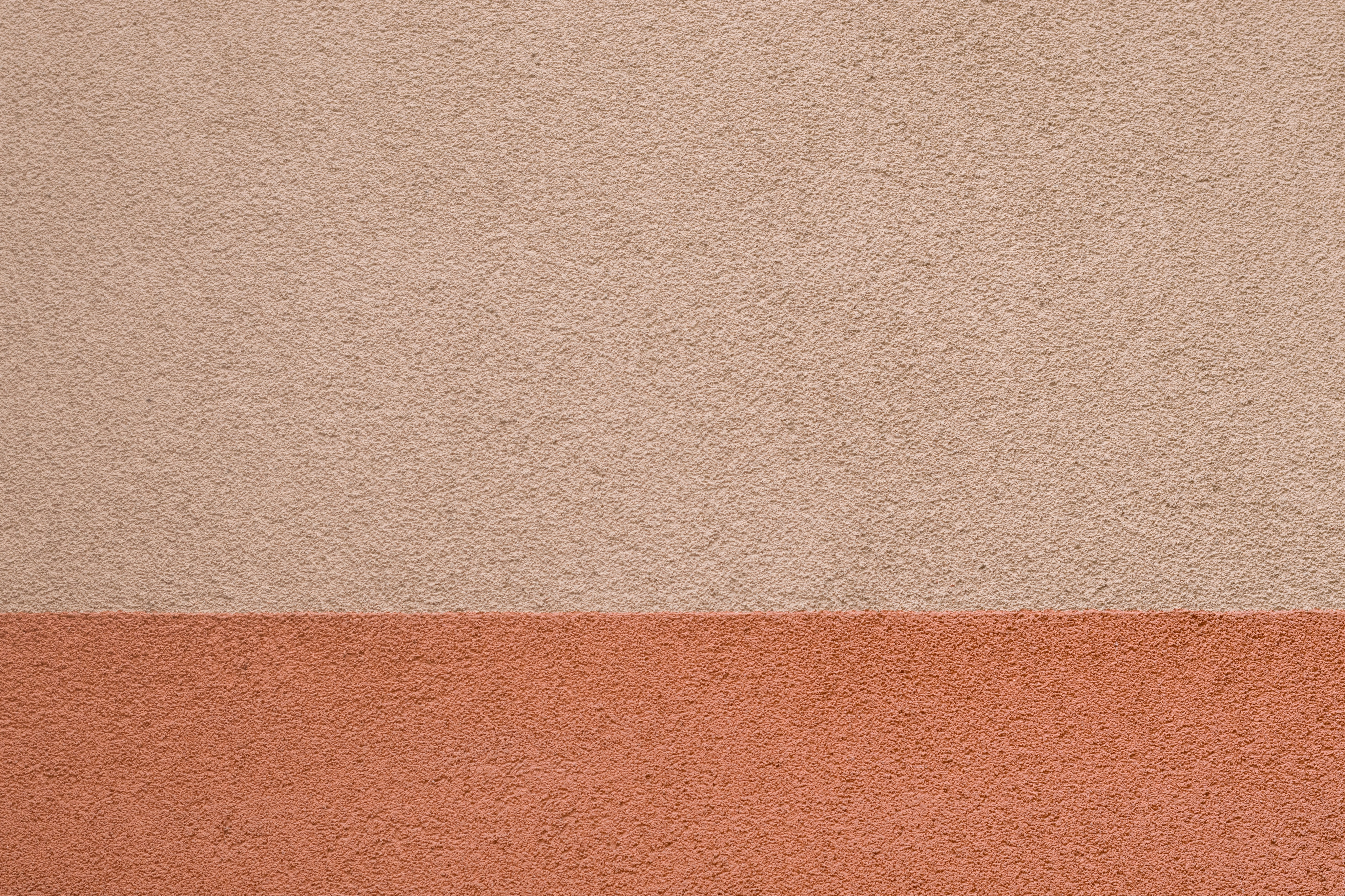 A textured wall with two distinct color blocks.