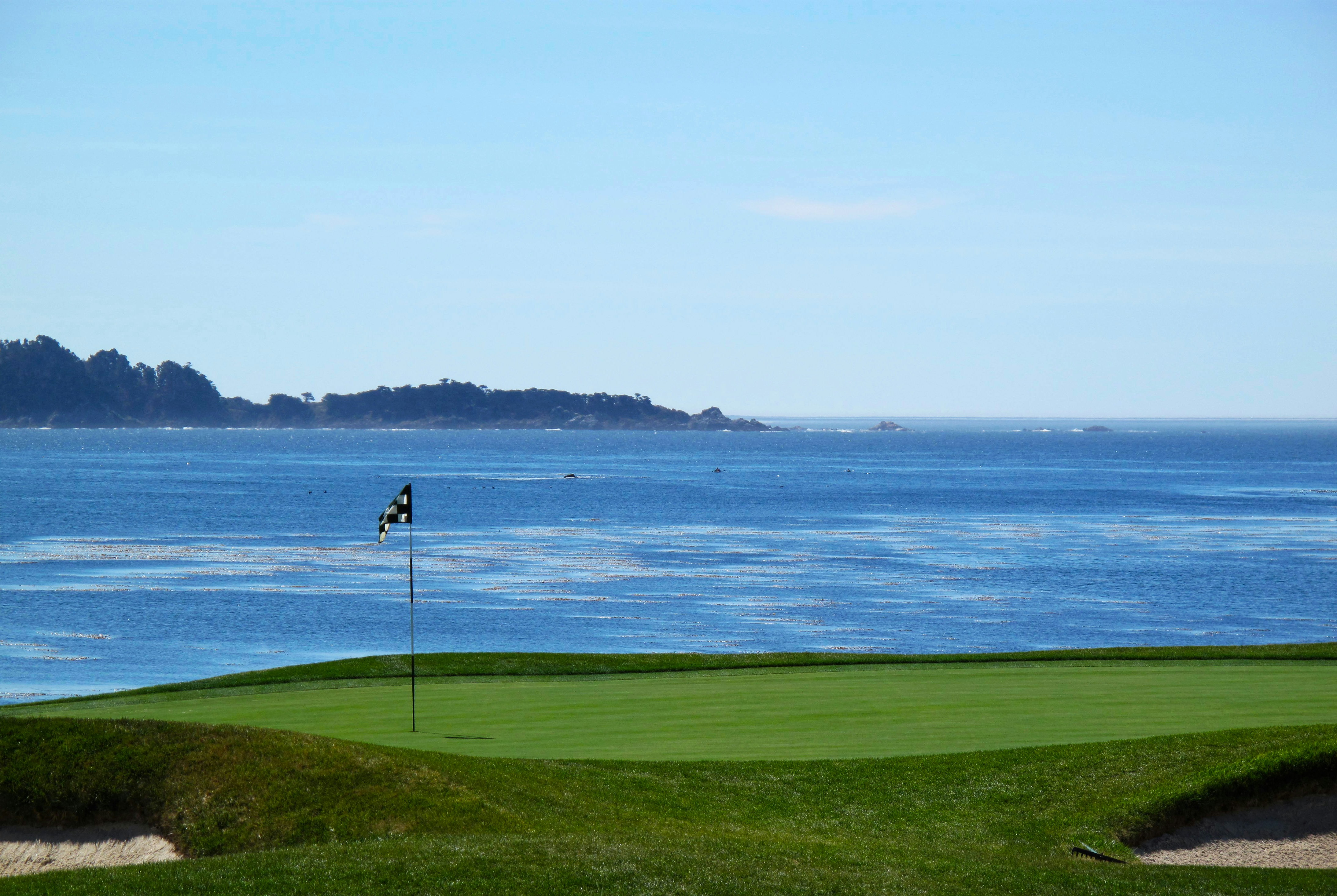 image of a golf course next to a beach 