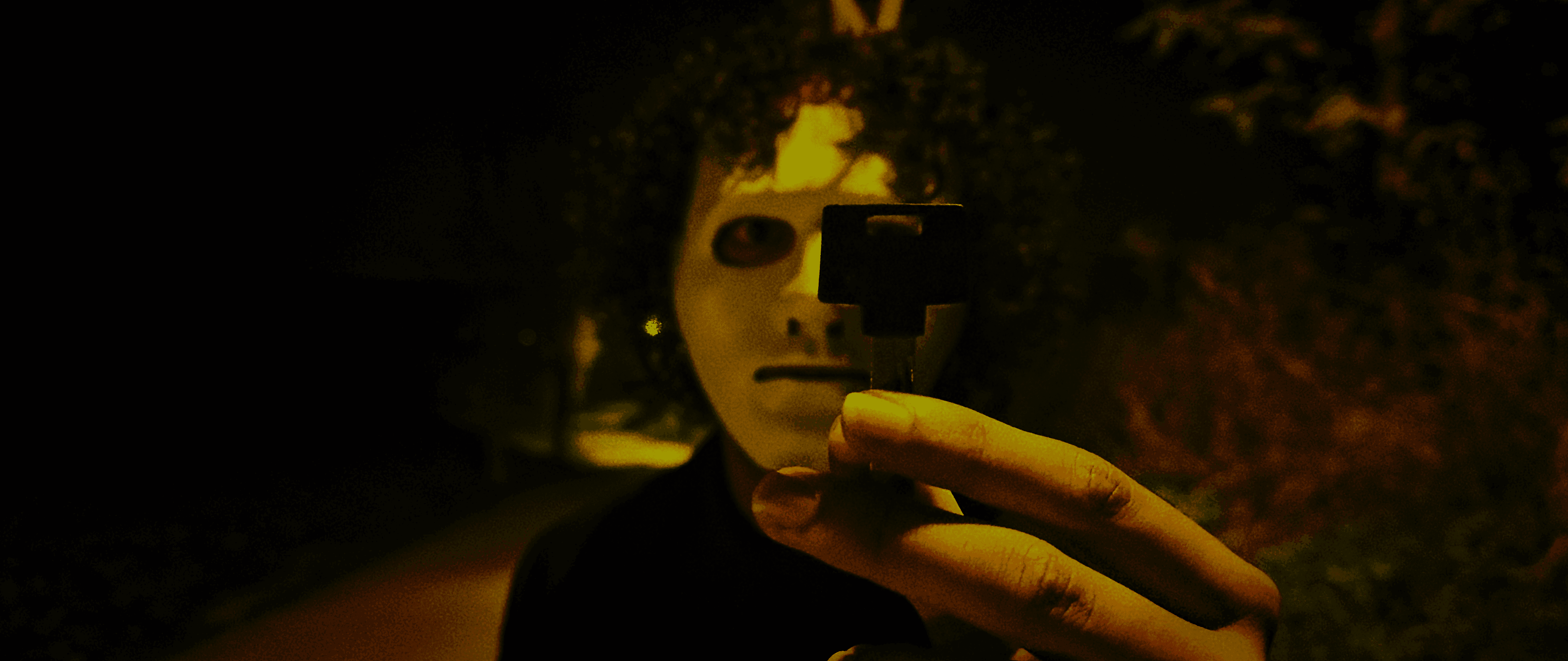 View of the French countryside through a stone villa’s open living room, with sofas and trees framing the scene