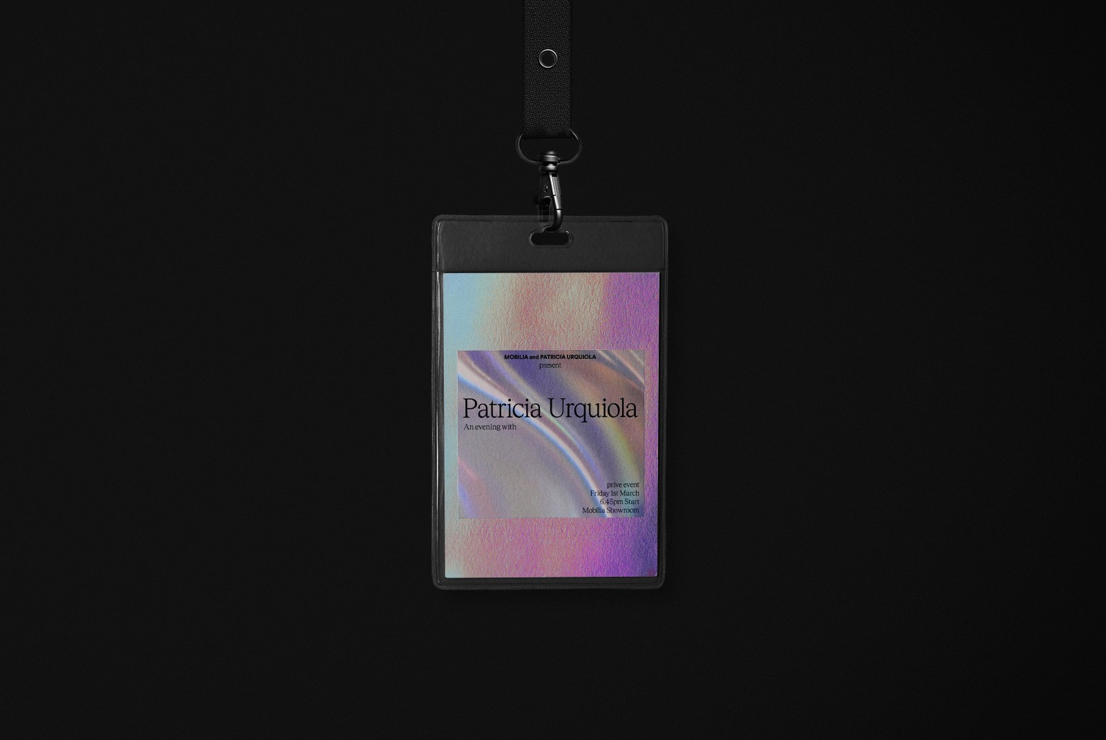 Close-up of a VIP event lanyard featuring an iridescent foil background and event details, designed as part of the Mobilia art direction. The lanyard design emphasizes exclusivity and high-quality materials.