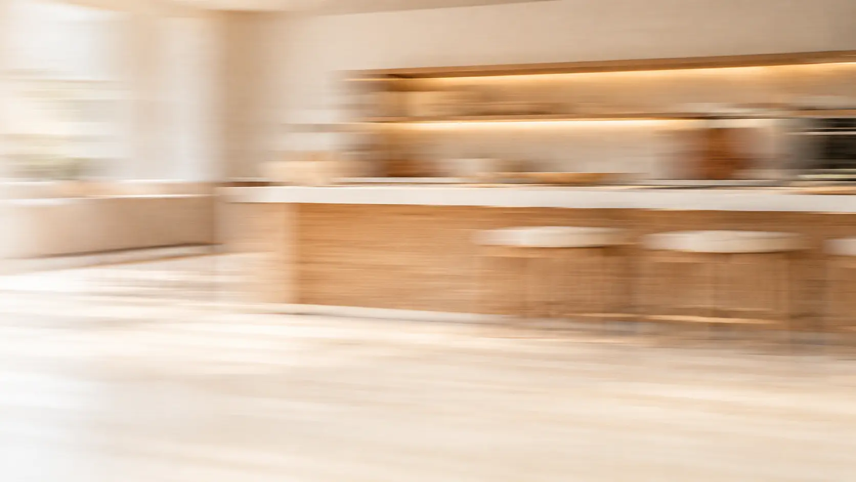 Daylit finishing room with furniture pieces, softly blurred by motion