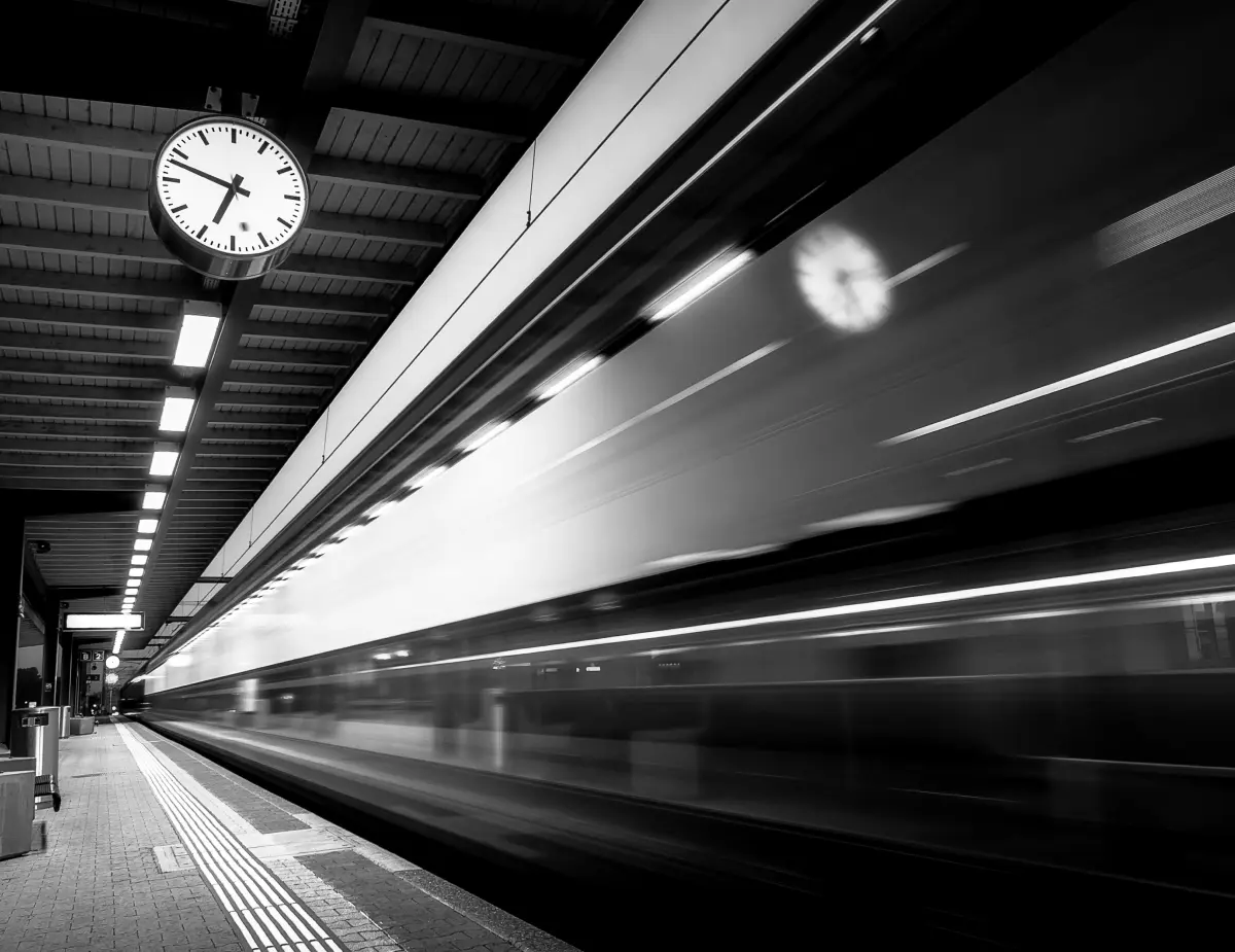grayscale photo of a train station