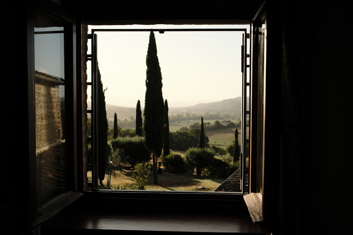 Tuscan countryside rolling past a train window, the slow scenic side of seeing Europe by train