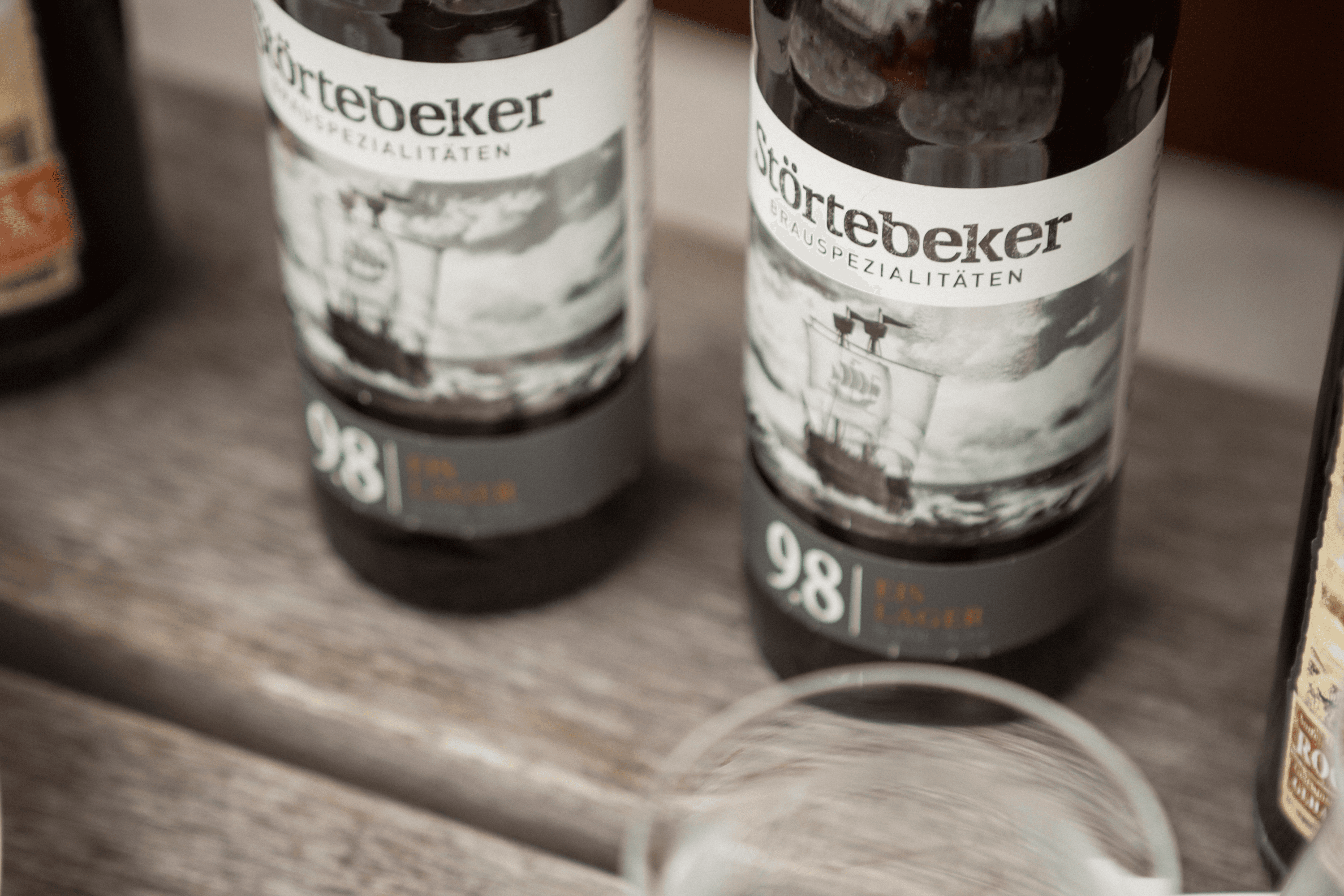Störtebeker beer bottles on a wooden surface.