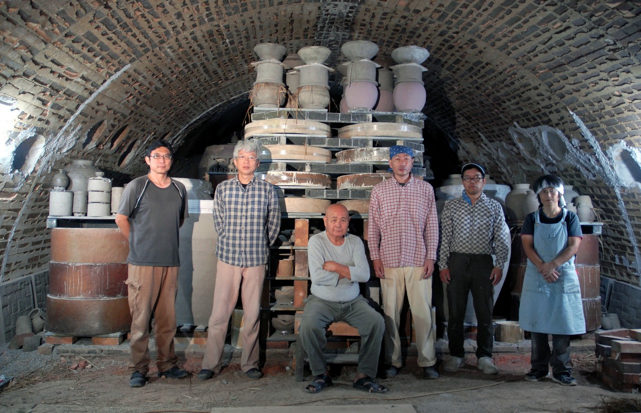 Swordsmiths hammering iron in a team