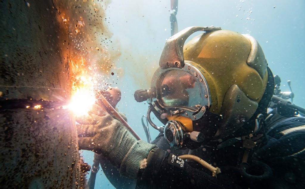 Historical profile image of an underwater welding operation.