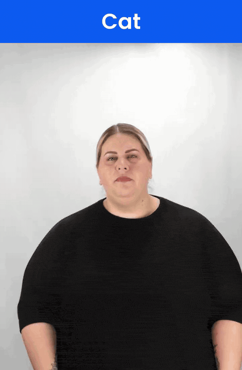 Animated GIF: a Deaf signer signs CAT in ASL, a pinched thumb and index finger pulling out from the cheek.