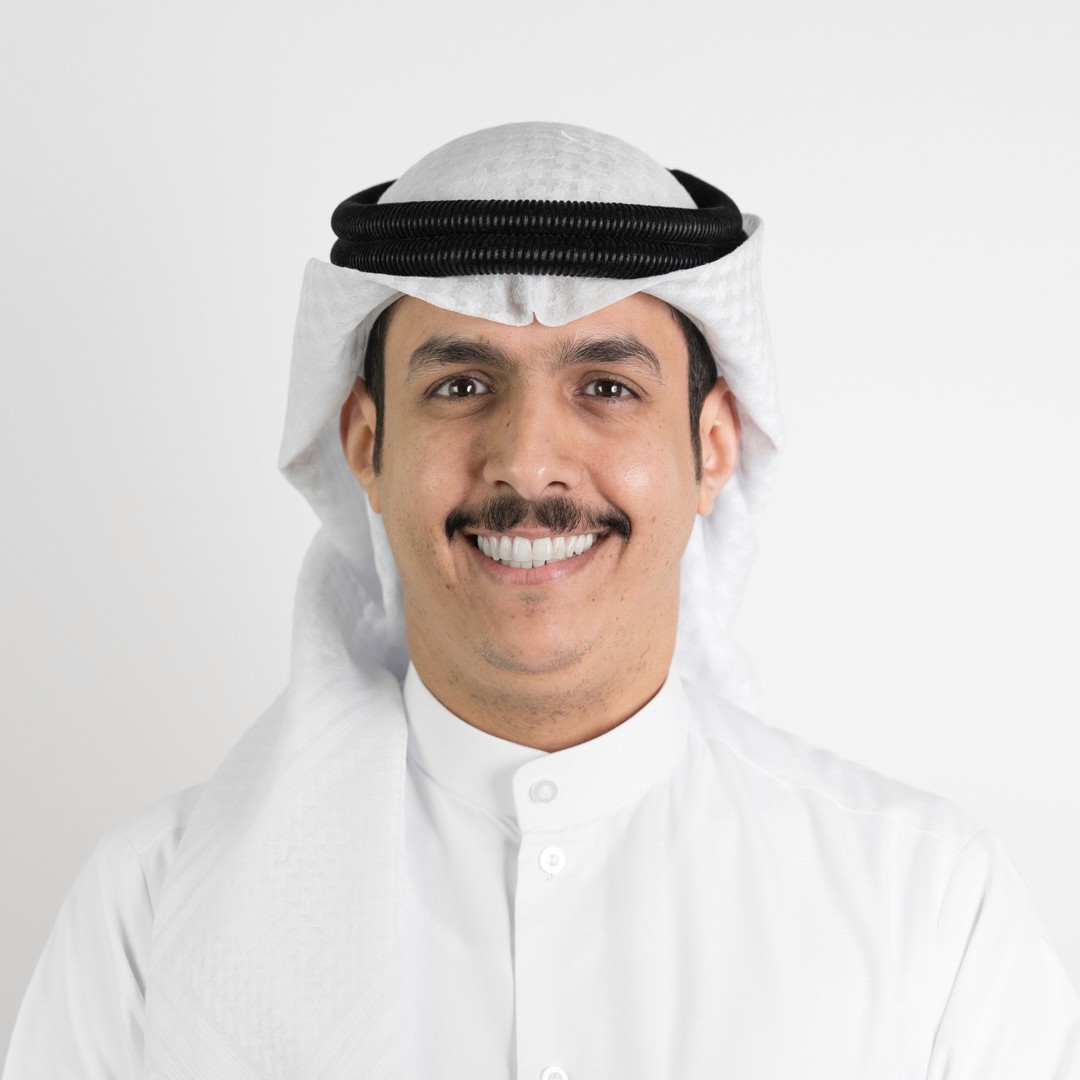 a woman in a white suit standing with her arms crossed