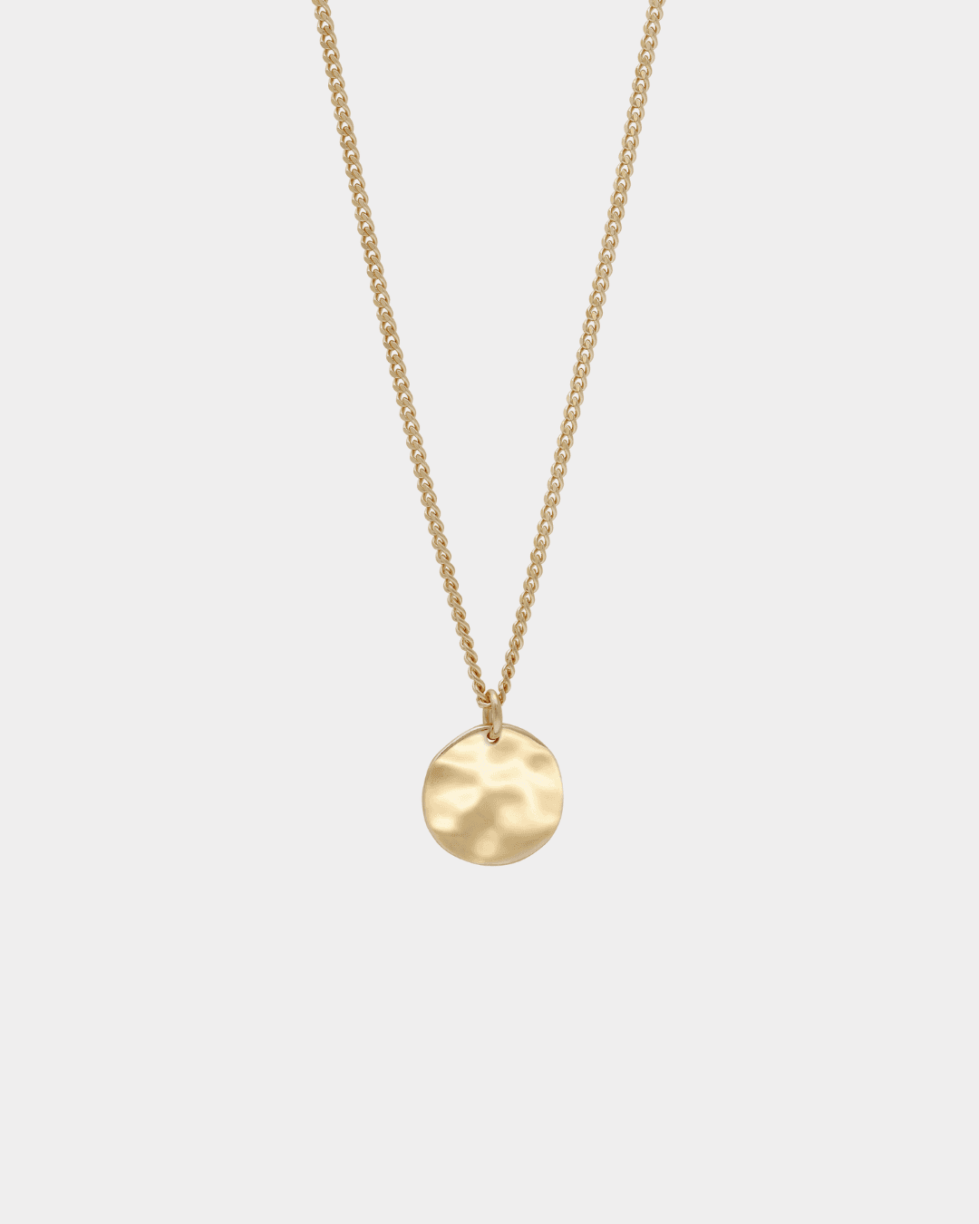 close up detail of front of gold pendant