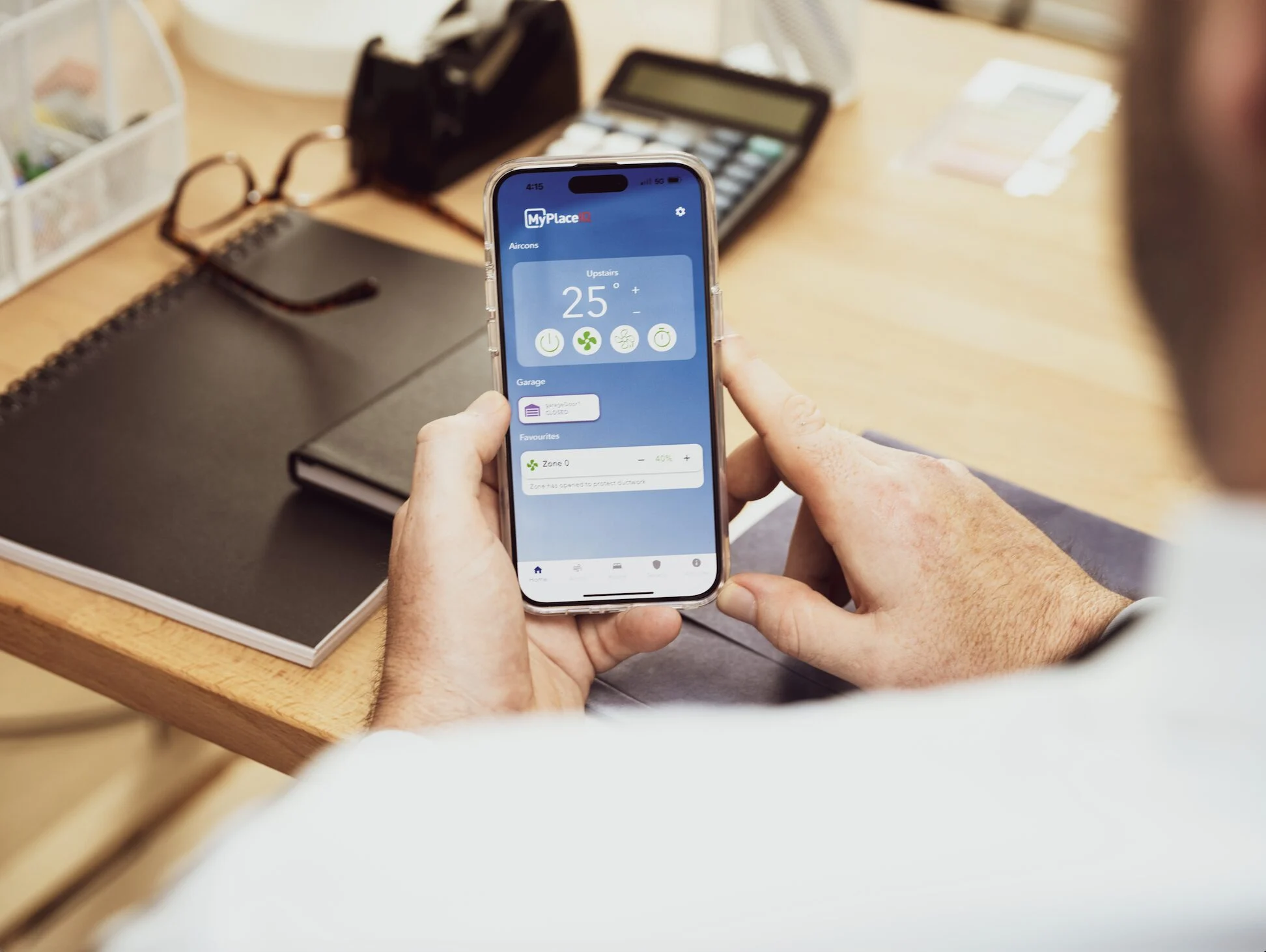A man using a smart phone with MyPlaceIQ app